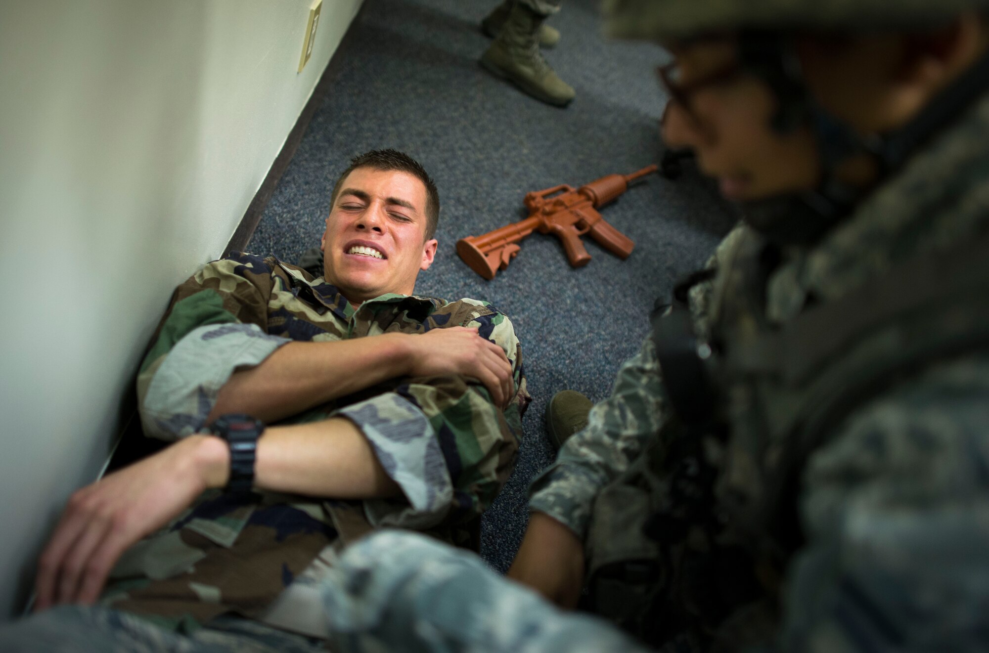 A role player lies in pain after being shot during an active shooter scenario part of readiness week at Yokota Air Base, Japan, Oct. 10, 2013. Several simulated victims were on-scene to add a sense of realism to the scenario. (U.S. Air Force photo by Staff Sgt. Chad C. Strohmeyer/Released)
