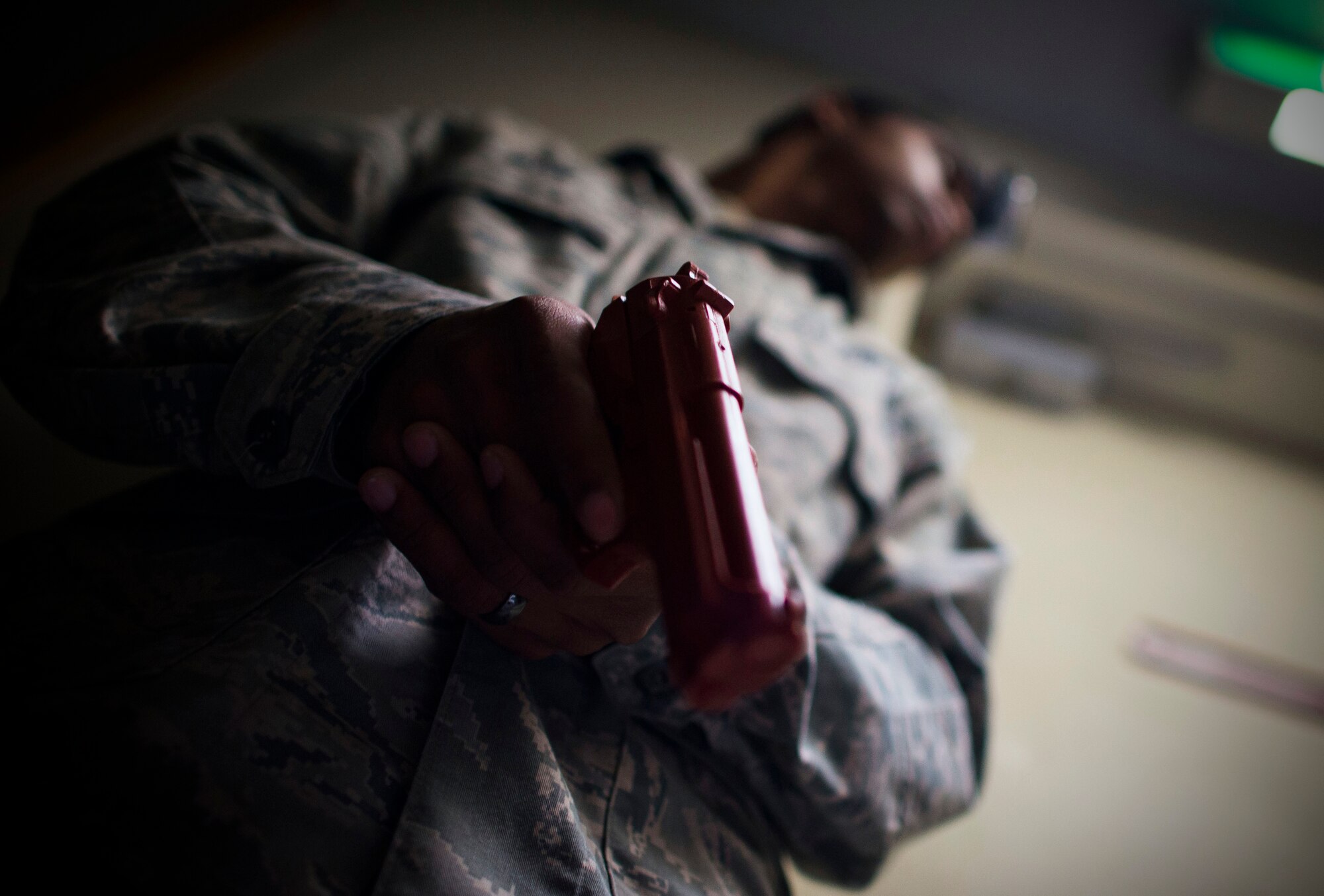 Senior Airman Lamon Irvin, 374th Logistics Readiness Squadron simulated active shooter, waits for 374th Security Forces personnel during an active shooter scenario part of readiness week at Yokota Air Base, Japan, Oct. 10, 2013. The scenario allowed security forces personnel to hone their skills during a contingency. (U.S. Air Force photo by Staff Sgt. Chad C. Strohmeyer/Released)