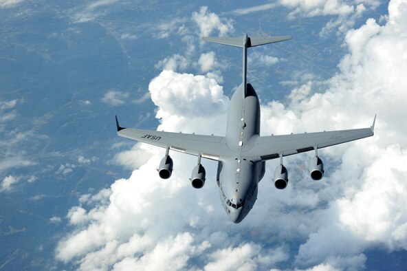 A C-17 Globemaster III from the 437th Airlift Wing, Joint Base Charleston, S.C., flies over Midwest skies, Oct. 4, 2013 during a training mission supported by an air refueling KC- 135 Stratotanker from McConnell Air Force Base, Kan. (U.S. Air Force photo/Staff Sgt. Jess Lockoski)