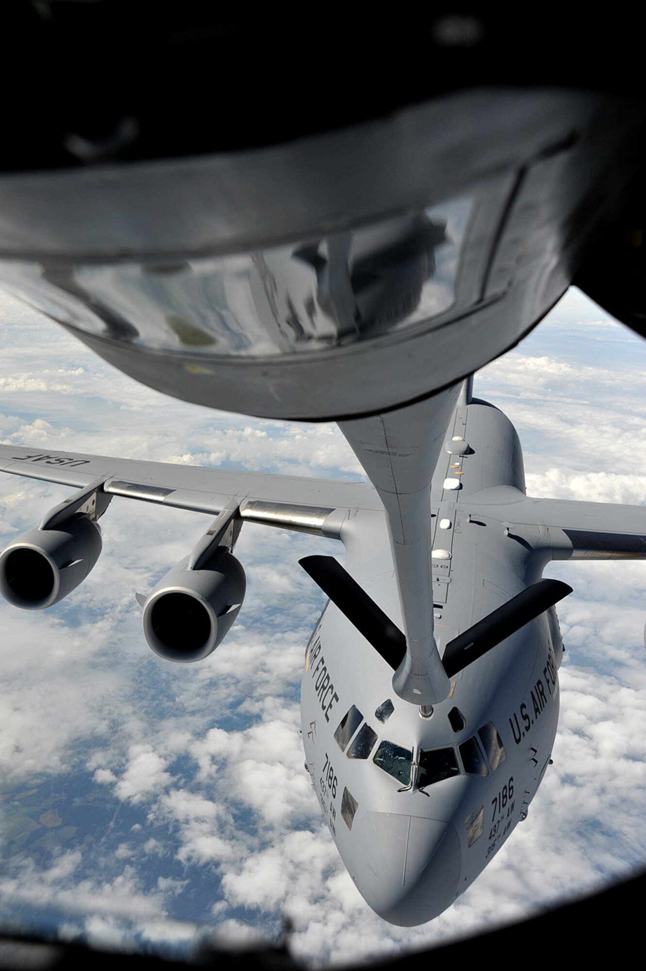 A C-17 Globemaster III from the 437th Airlift Wing, Joint Base Charleston, S.C., advances to make contact with a KC-135 Stratotanker from the 22nd Air Refueling Wing, McConnell Air Force Base, Kan., Oct. 4, 2013 during a refueling mission over Kentucky. Air refueling training missions keep Airmen from McConnell’s four flying squadrons proficient in all essential aspects of air-to-air refueling, helping extend global reach for American and coalition aircraft. (U.S. Air Force photo/Staff Sgt. Jess Lockoski) 
