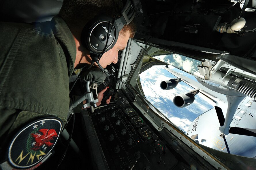 Senior Airman Travis Moore, 350th Air Refueling Squadron boom operator, McConnell Air Force Base, Kan., maneuvers the boom of a KC-135 Stratotanker and makes contact with the receptacle of a C-17 Globemaster III from the 437th Airlift Wing, Joint Base Charleston, S.C., Oct. 4, 2013 during a refueling mission over Kentucky. Moore is an Oklahoma City, Okla., native and one of more than 130 boom operators assigned to the 22nd Air Refueling Wing. Despite a week of partial government shutdown, McConnell’s flying operations continued as scheduled, to support air mobility, airlift and national security. (U.S. Air Force photo/Staff Sgt. Jess Lockoski) 

