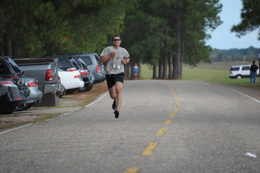 A student from Air Command and Staff College competes in a 5K race on Maxwell Air Force Base, Oct. 8. The race was part of a 2-day competition between ACSC and Air War College, compiling of approximately 20 events, both scholastic and athletic. (U.S. Air Force photo by Airman 1st Class William Blankenship)