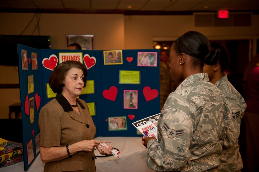 Airmen from Dyess Air Force Base receive information from Cecilia Barahona, Area Manager for the Friends for Life program during the Combined Federal Campaign kickoff Oct. 4, 2013, at Dyess Air Force Base, Texas. Federal employees have the option to select one or more charities to donate to from a list of thousands of organizations that participate in the CFC. Federal employees have until Oct. 15 to select a charity to donate to. (U.S. Air Force photo by Airman 1st Class Alexander Guerrero/Released)