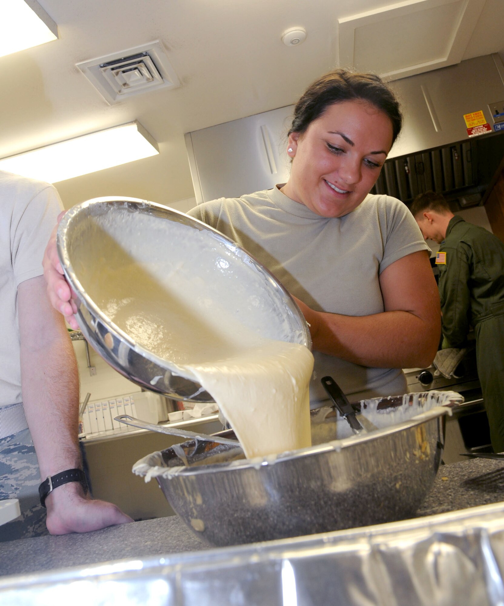 2nd Lt. Geri Veilleux, with the 71st Student Squadron, pours mixed pancake batter into a bowl for the volunteer cooks during the Combined Federal Campaign breakfast kick off Oct. 3 in the Community Chapel Activity Center at Vance Air Force Base, Okla. Unit representatives for the CFC hosted the breakfast to give Airmen a convenient opportunity to make their donations. (U.S. Air Force photo/ Senior Airman Frank Casciotta)