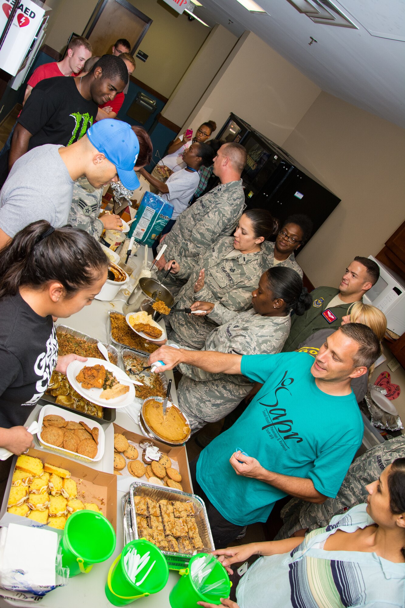 Members of the 375th Air Mobility Wing and Sexual Assault Prevention and Response team serve food to Airmen at the “Airmen Dinner” Sept. 18, 2013 at Scott Air Force Base, Ill. The dinner gave Airmen a chance to socialize and meet members of the chapel and SAPR. (U.S. Air Force photo/Staff Sgt. Jonathan Fowler)