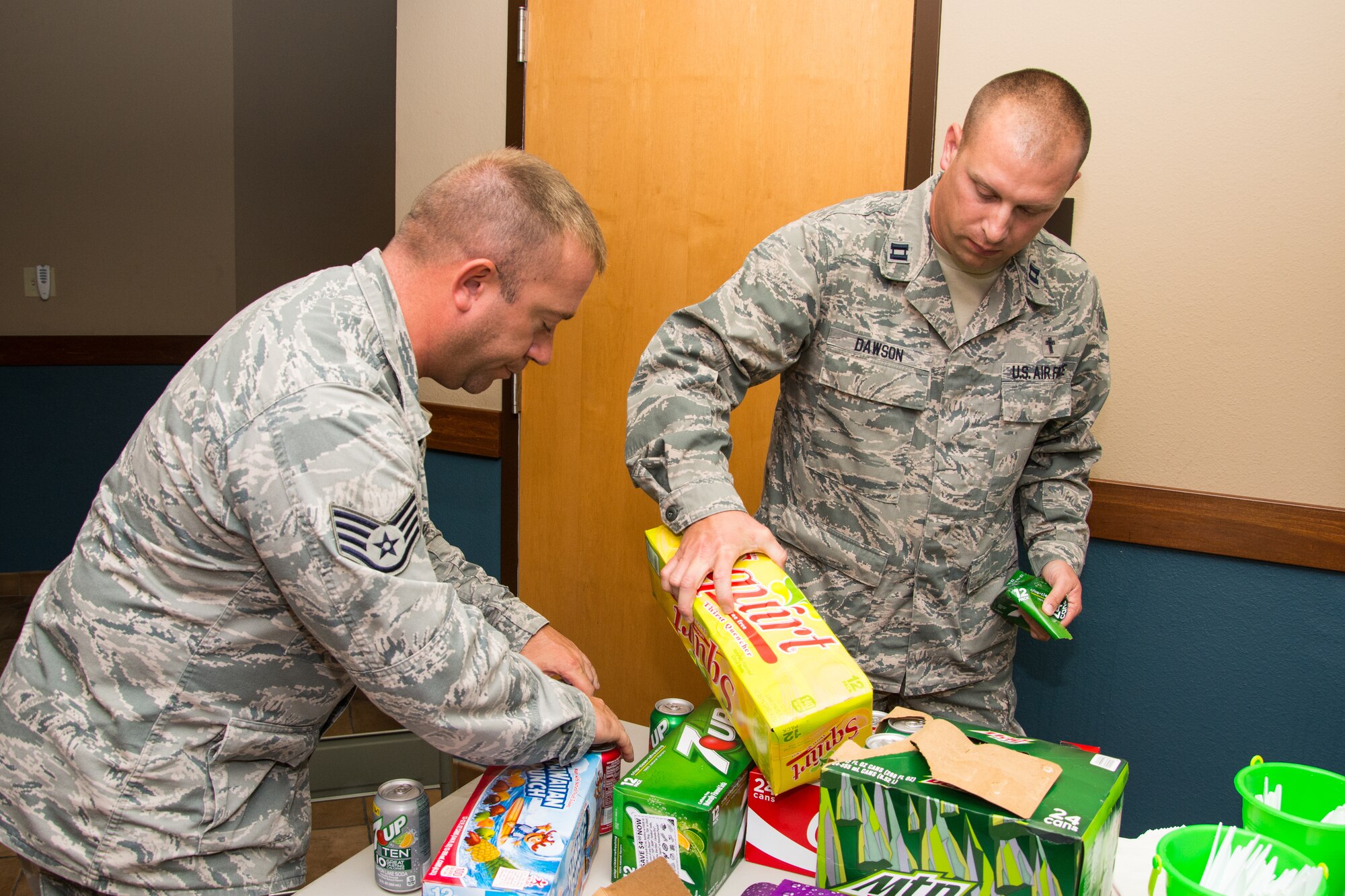 Staff Sgt. Todd Vetter and Capt. (Chaplain) Nathan Dawson set out drinks for the “Airmen Dinner” Sept. 18, 2013 at Scott Air Force Base, Ill. The 375th Air Mobility Wing chapel as well as other base organizations host the event as a way to reach out to Airmen. Vetter is a chaplain assistant and Dawson is a chaplain for the 375th AMW. (U.S. Air Force photo/Staff Sgt. Jonathan Fowler)