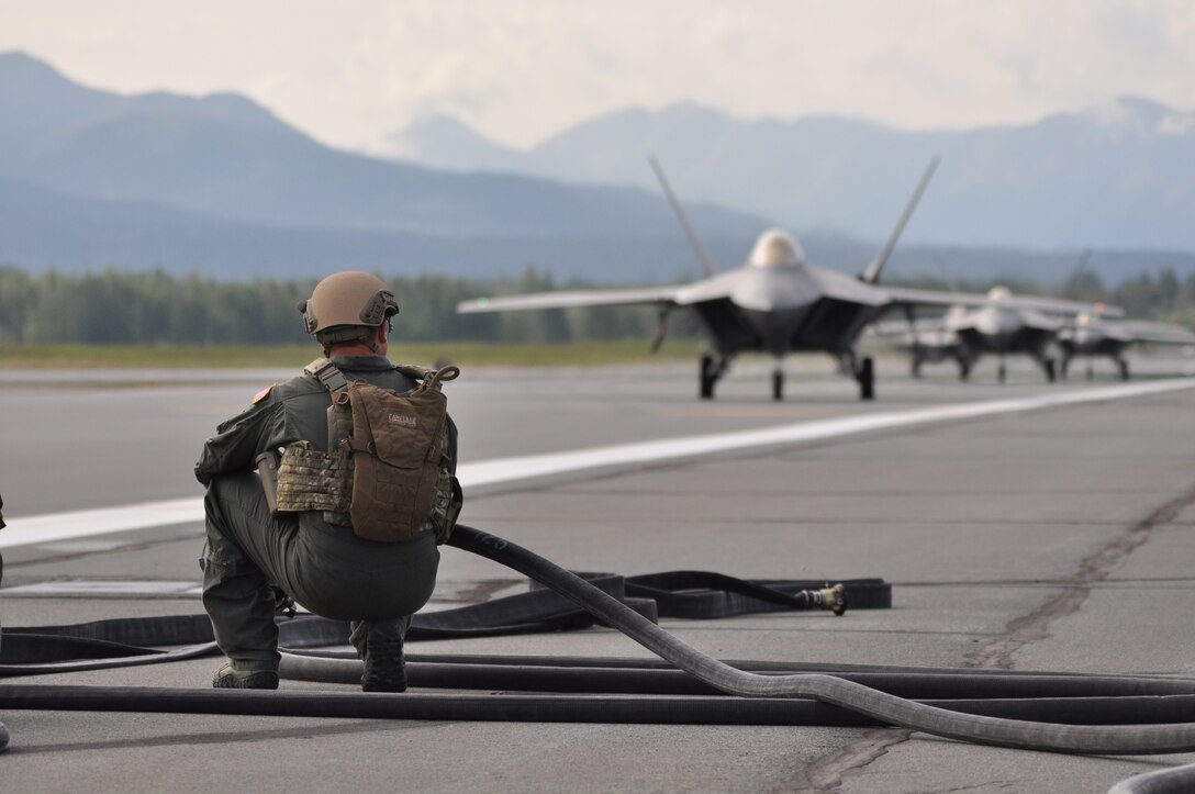 A fuels specialist awaits the arrival of 3rd Wing F-22s to begin refueling. The newest strategy in fighter employment will enable combat-ready F-22’s to rapidly refuel, rearm, and redeploy in record time and was demonstrated here during joint exercises in August.  The new concept was developed by Lt. Col. Kevin Sutterfield, a Reserve F-22 pilot assigned to the 477th Fighter Group. (U.S. Air Force photo/Tech. Sgt. Dana Rosso) 
