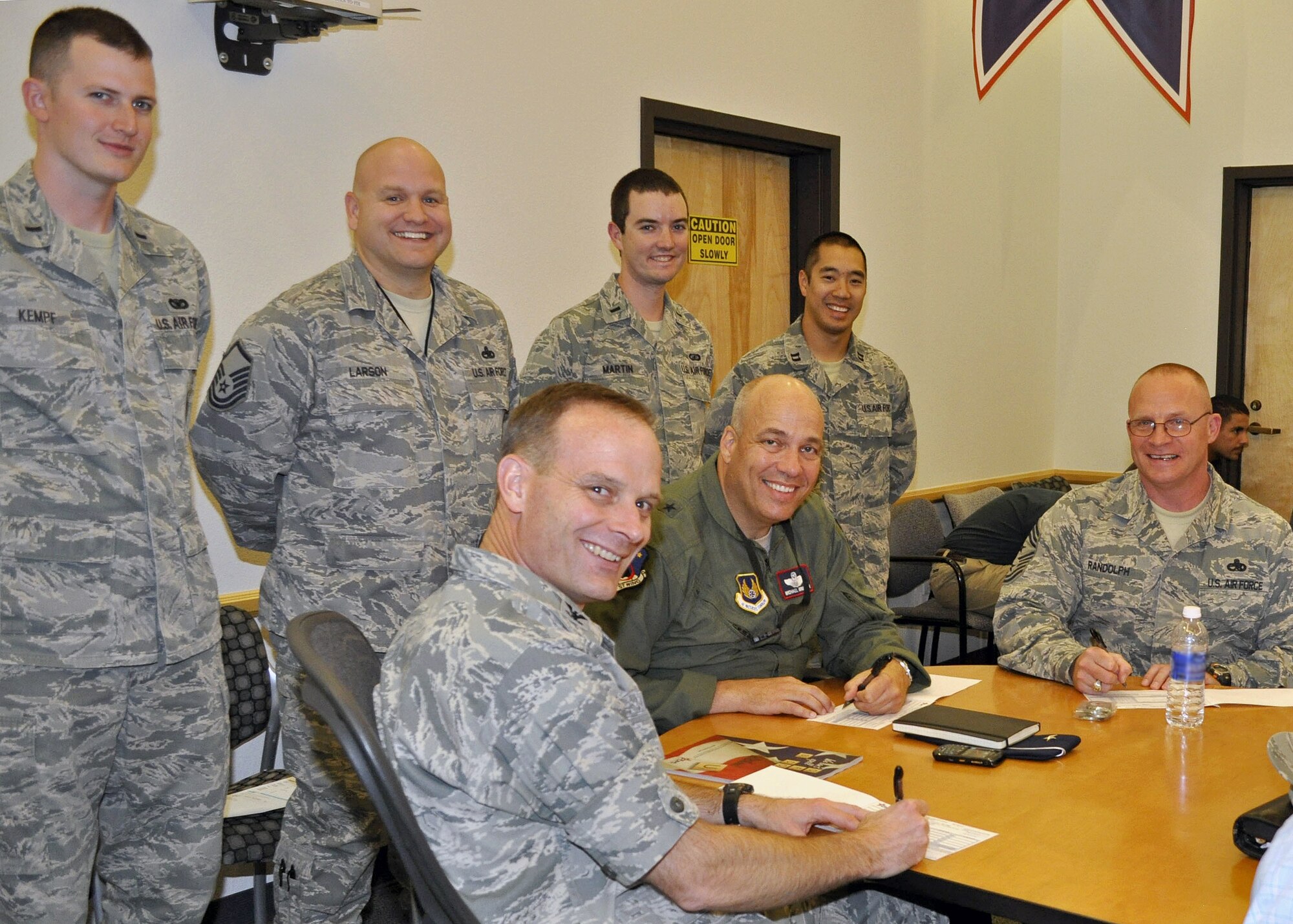 (Seated from left to right) Col. Daniel Daetz, 412th Test Wing vice commander, Brig. Gen. Michael Brewer, 412th TW commander, and Chief Master Sgt. Brian Randolph, 412th TW command chief, sign their Combined Federal Campaign pledge forms among CFC installation representatives on Oct. 1, prior to the CFC kick off which occurred Oct. 8. This year's campaign runs till Nov. 22. (U.S. Air Force courtesy photo)