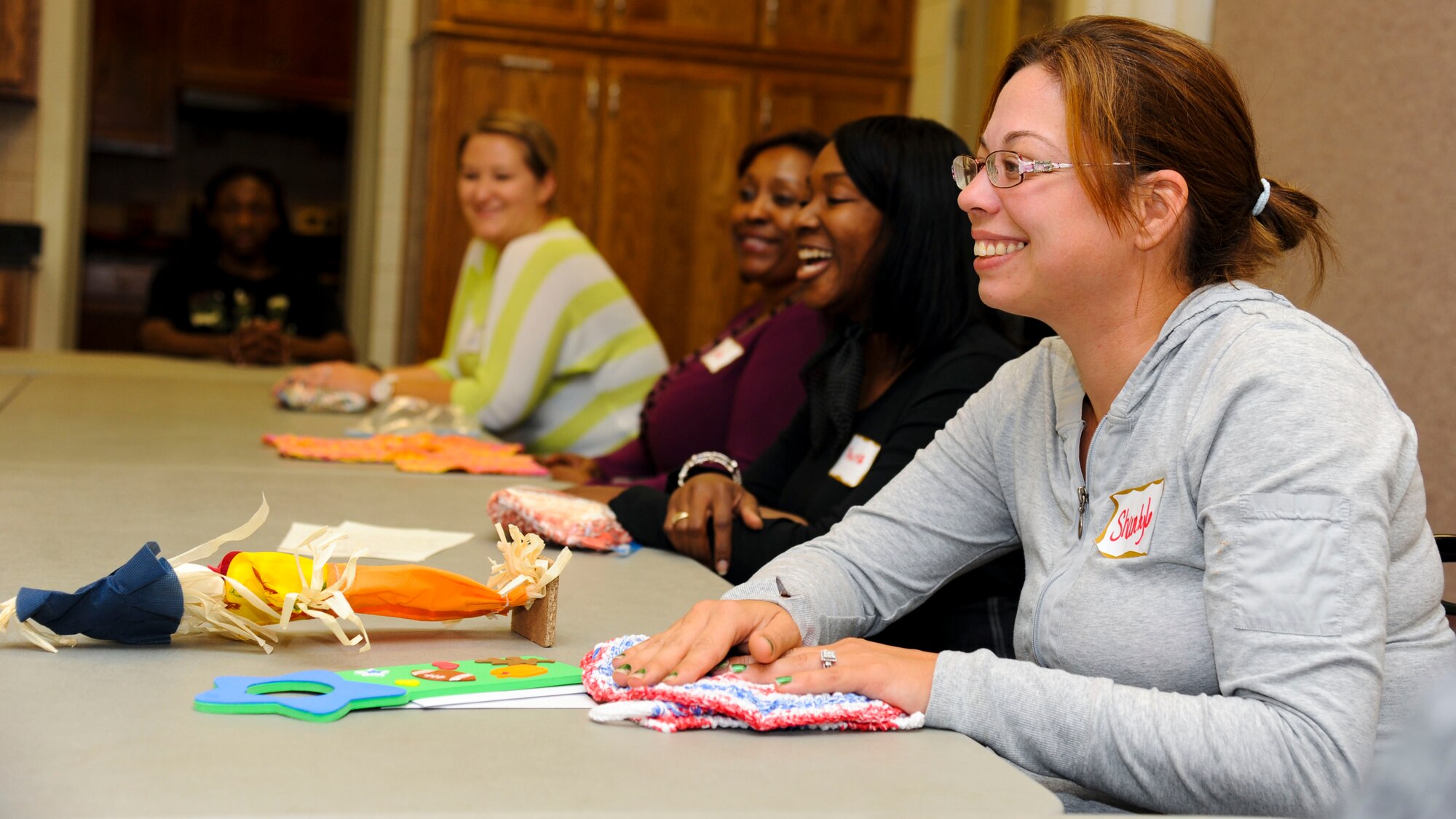 Shantyle Power, wife of a deployed Soldier, receives gifts from the chapel community during a dinner for families of deployed Service members at Fort Eustis, Oct. 8, 2013. Family members then talked with a chaplain and each other during a discussion group. (U.S. Air Force photo by Airman 1st Class Austin Harvill/Released)