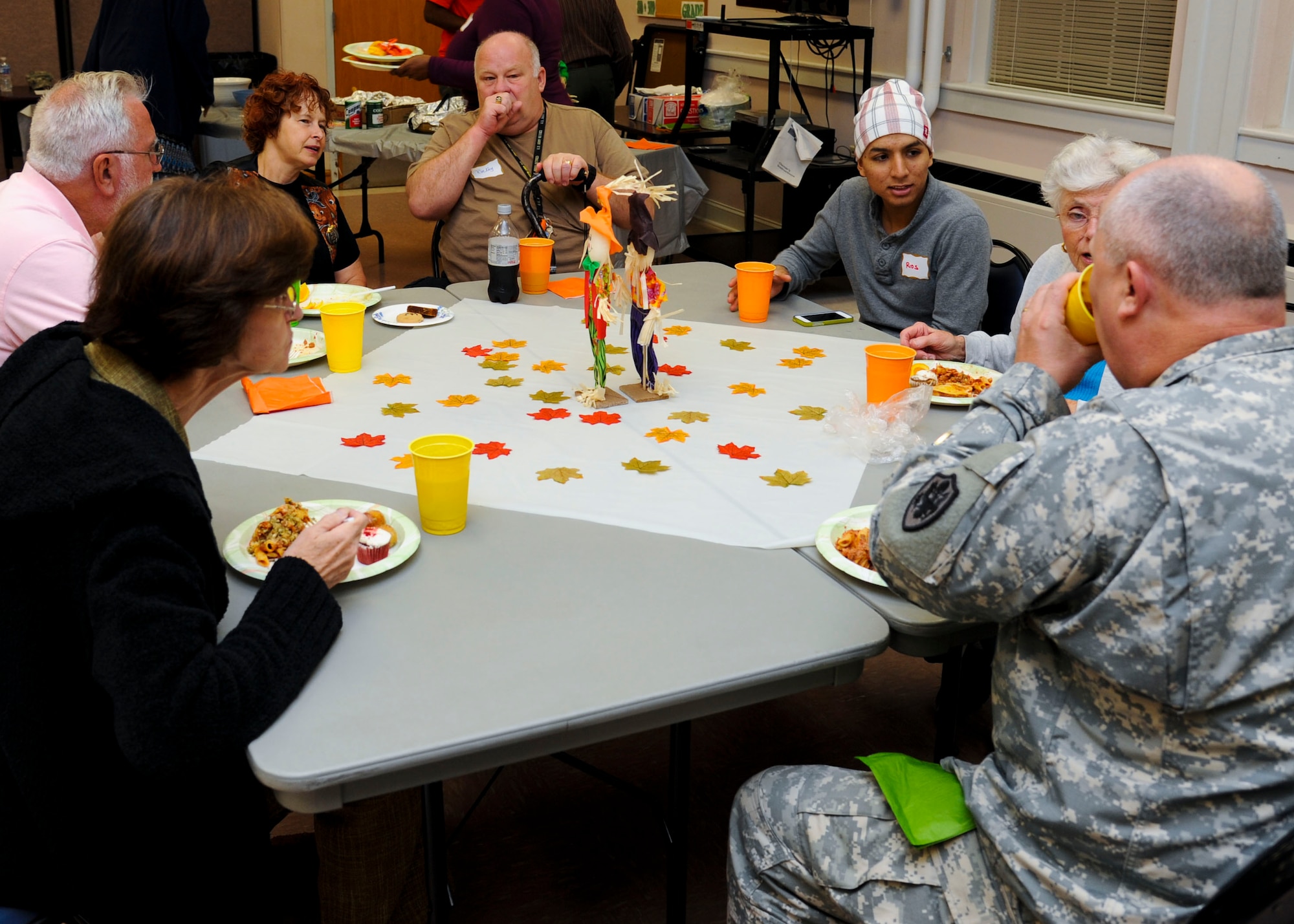 Family members and Fort Eustis, Va., Memorial Chapel staff members discuss hardships during a dinner for families of deployed Service members at Fort Eustis, Oct. 8, 2013. The chapel provided dinner and dessert for the participants. (U.S. Air Force photo by Airman 1st Class Austin Harvill/Released)