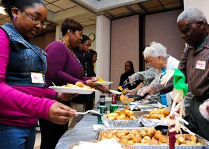 Families line up for dinner in the chapel at Fort Eustis, Va., Oct. 8, 2013. The chapel hosted a dinner for families of deployed Service members, where families could discuss hardships and find support in one another. (U.S. Air Force photo by Airman 1st Class Austin Harvill/Released)