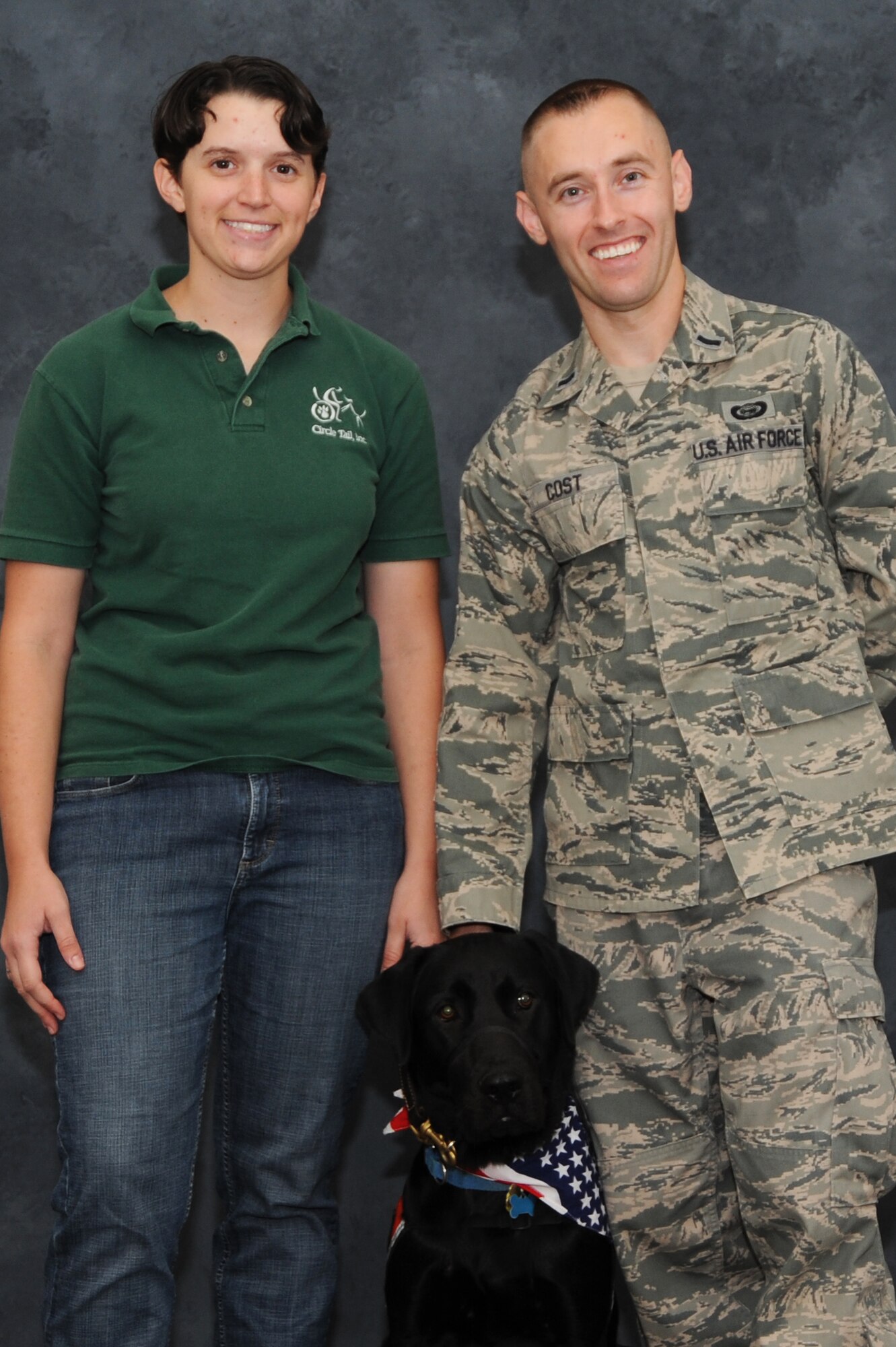 1st Lt. Robert Cost and Emily Cost pose with their new foster dog, Bexley at Scott Air Force Base, Sep. 30, 2013.The Costs both have been fostering dogs more than five years. (U.S. Air Force photo/Airman Megan Friedl)