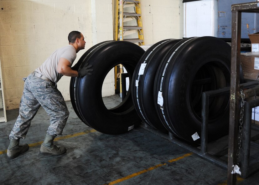 Staff Sgt. Micheal Heger, 2nd Logistics Readiness Squadron mobility readiness spares package supervisor, pushes a B-52H Stratofortress tire onto a pick-up and delivery rack on Barksdale Air Force Base, La., Oct. 4, 2013. The tires will be picked up by vehicle operations and delivered to the flightline for installation on a B-52. (U.S. Air Force photo/Senior Airman Joseph A. Pagán Jr.)