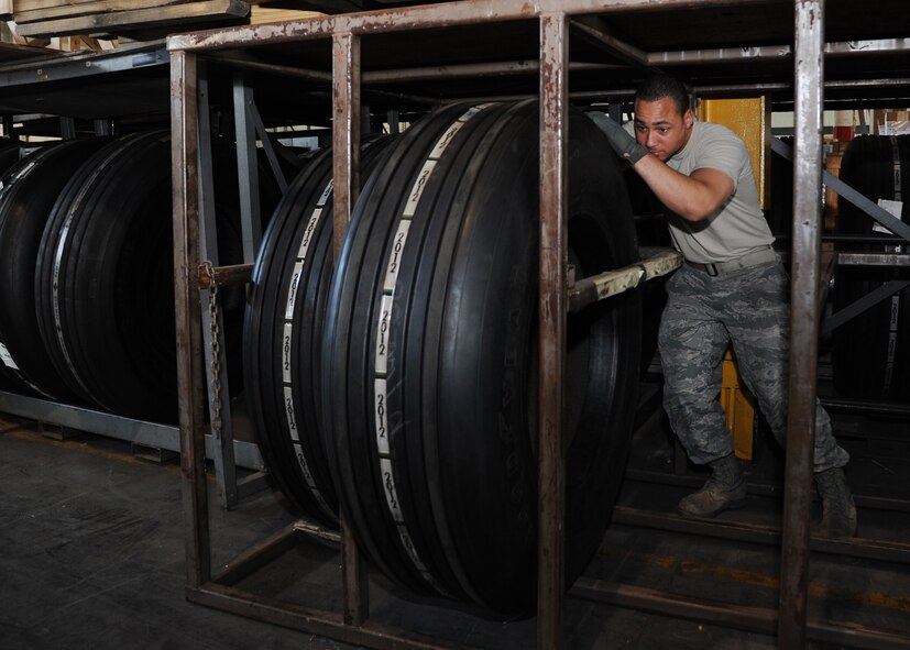Staff Sgt. Micheal Heger, 2nd Logistics Readiness Squadron mobility readiness spares package supervisor, rolls a tire from a rack on Barksdale Air Force Base, La., Oct. 4, 2013. Heger moved a B-52H Stratofortress tire to the pick-up and delivery section of the 2nd LRS warehouse. The tire will be picked up by vehicle operations and delivered to the flightline for use. (U.S. Air Force photo/Senior Airman Joseph A. Pagán Jr.)
