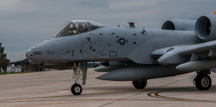 An A-10C Thunderbird II pilot raises his arms to a crowd on Moody Air Force Base, Ga., Oct. 8, 2013. A total of 11 pilots and aircraft returned home from a six-month deployment to Bagram Airfield, Afghanistan. (U.S. Air Force photo by Airman 1st Class Alexis Grotz/Released)