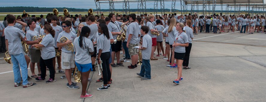 The Lowndes High Georgia Bridgemen marching band forms up to perform as pilots and A-10C Thunderbird II aircraft of the 74th Fighter Squadron return from deployment on Moody Air Force Base, Ga., Oct. 8,2013. The band played a number of songs as Airmen and their families reunited. (U.S. Air Force photo  by Airman 1st Class Alexis Grotz/Released)