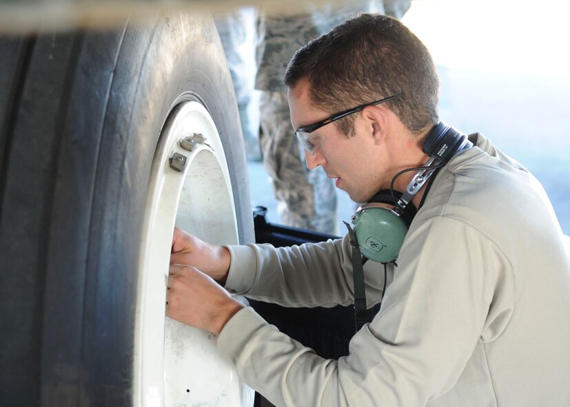 Senior Airman Jacob Andrews, 2nd Aircraft Maintenance Squadron crew chief, attaches safety wire to an anti-skid dust cover on a B-52H Stratofortress on Barksdale Air Force Base, La., Oct. 8, 2013. The dust cover keeps debris from getting into the anti-skid components that are attached to the brakes. (U.S. Air Force photo/Senior Airman Kristin High)