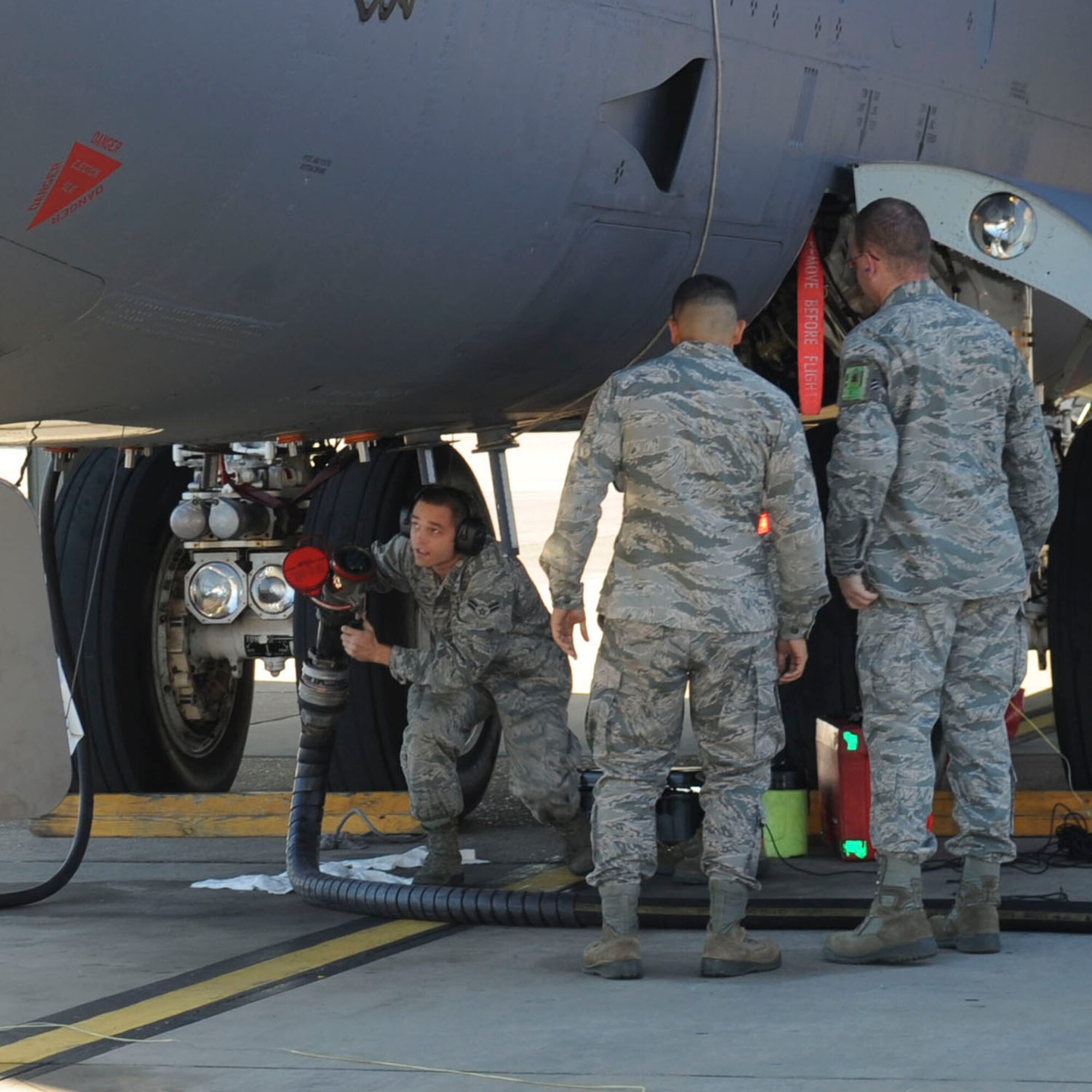 Airmen from 2nd Aircraft Maintenance Squadron watch as Airman 1st Class Samuel Amatrudi, 2nd AMXS crew chief, hooks a single-point refuel hose to a B-52H Stratofortress on Barksdale Air Force Base, La., Oct. 8, 2013. The use of aerial refueling gives the B-52 a range limited only by crew endurance. It has an unrefueled combat range in excess of 8,800 miles. (U.S. Air Force photo/Senior Airman Kristin High)