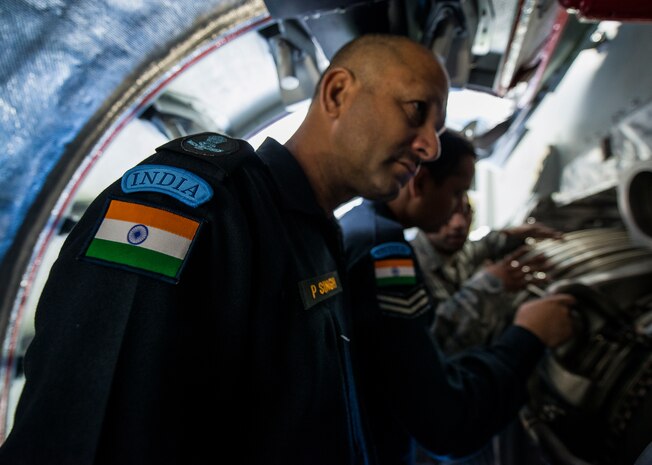An Indian Air Force member looks at a C-17 Globemaster III engine while Senior Airman Roshan Joseph 437th Aircraft Maintenance Squadron aerospace propulsion maintainer, goes over how the engine works Oct. 10, 2013, at Joint Base Charleston, S.C. Joseph has taught several Indian Air Force classes while stationed at JB Charleston. When previous class members of his return to the base with an Indian Air Force C-17 he takes his current class out to the aircraft to meet with the crew. (U.S. Air Force photo/ Senior Airman Dennis Sloan)