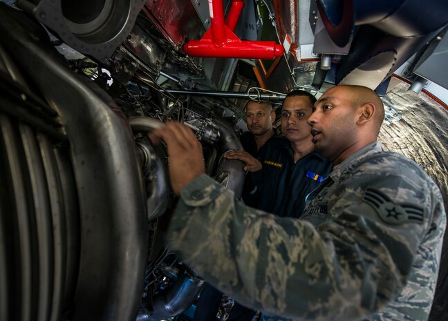 Senior Airman Roshan Joseph 437th Aircraft Maintenance Squadron, aerospace propulsion maintainer, teaches two Indian Air Force maintainer students about the C-17 Globemaster III engine they will be working on in India Oct. 10, 2013, at Joint Base Charleston, S.C. Joseph has taught several Indian Air Force classes while stationed at JB Charleston. When previous class members of his return to the base with an Indian Air Force C-17 he takes his current class out to the aircraft to meet with the crew. (U.S. Air Force photo/ Senior Airman Dennis Sloan)