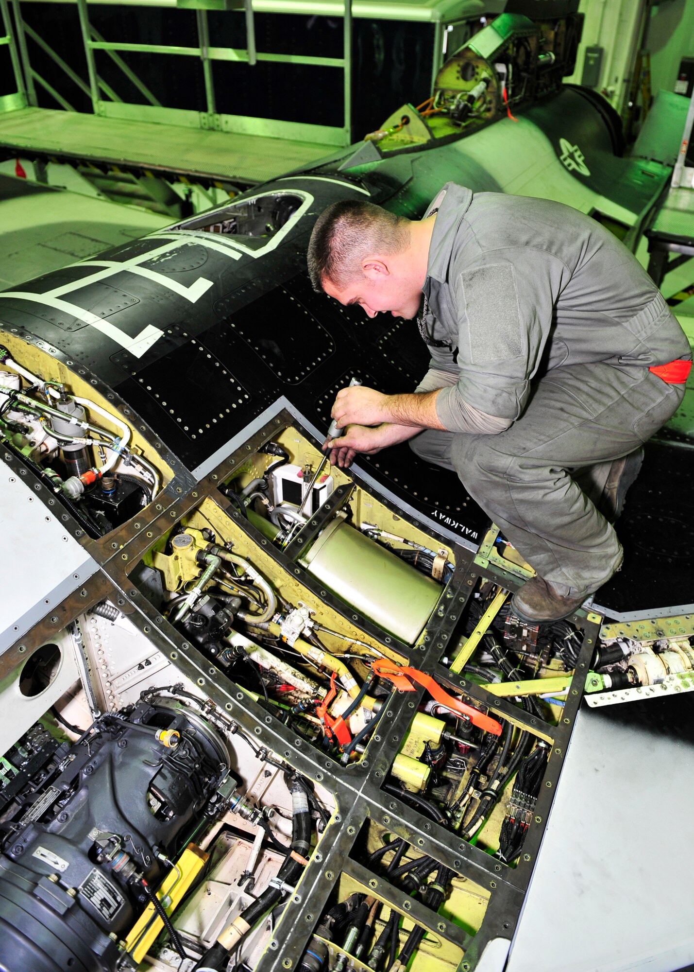 Staff Sgt. Dean Bloomberg, 354th Aircraft Maintenance Squadron dedicated crew chief, performs a hydraulic inspection Oct. 7, 2013, Eielson Air Force Base, Alaska. The purpose of a hydraulic inspection is to ensure the integrity of the hydraulic system, making it safe to fly. (U.S. Air Force photo by Senior Airman Ashley Nicole Taylor/Released)