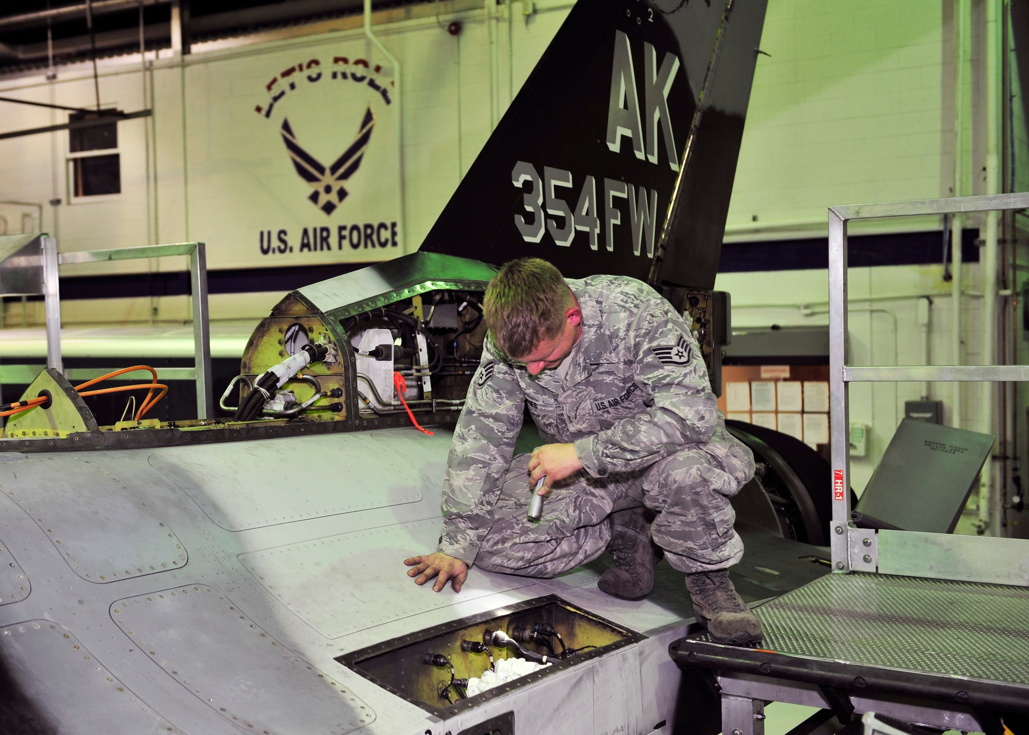 Staff Sgt. Michael Jones, 354th Maintenance Squadron electrical and environmental craftsman, inspects wires for chafing Oct. 7, 2013, Eielson Air Force Base, Alaska. The entire aircraft is inspected for corrosion, defective pieces and chafing. (U.S. Air Force photo by Senior Airman Ashley Nicole Taylor/Released)