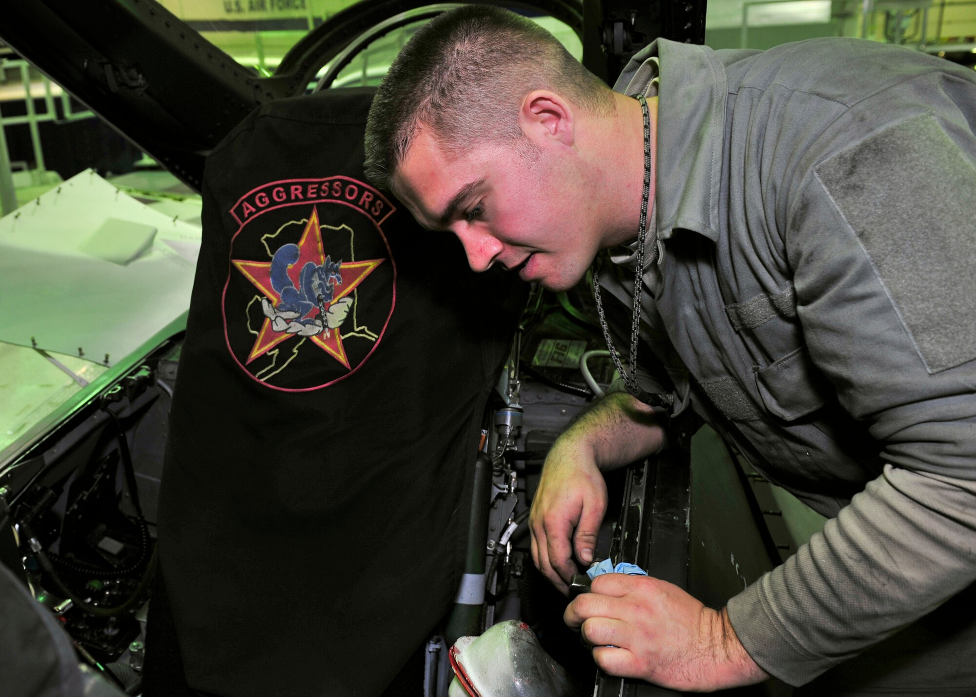 Staff Sgt. Dean Bloomberg, 354th Aircraft Maintenance Squadron dedicated crew chief, performs a visual inspection of the throttle in the cockpit of an F-16 Fighting Falcon Oct. 7, 2013, Eielson Air Force Base, Alaska. The phase crew takes up to two weeks with an aircraft ensuring it is safe to fly. (U.S. Air Force photo by Senior Airman Ashley Nicole Taylor/Released)