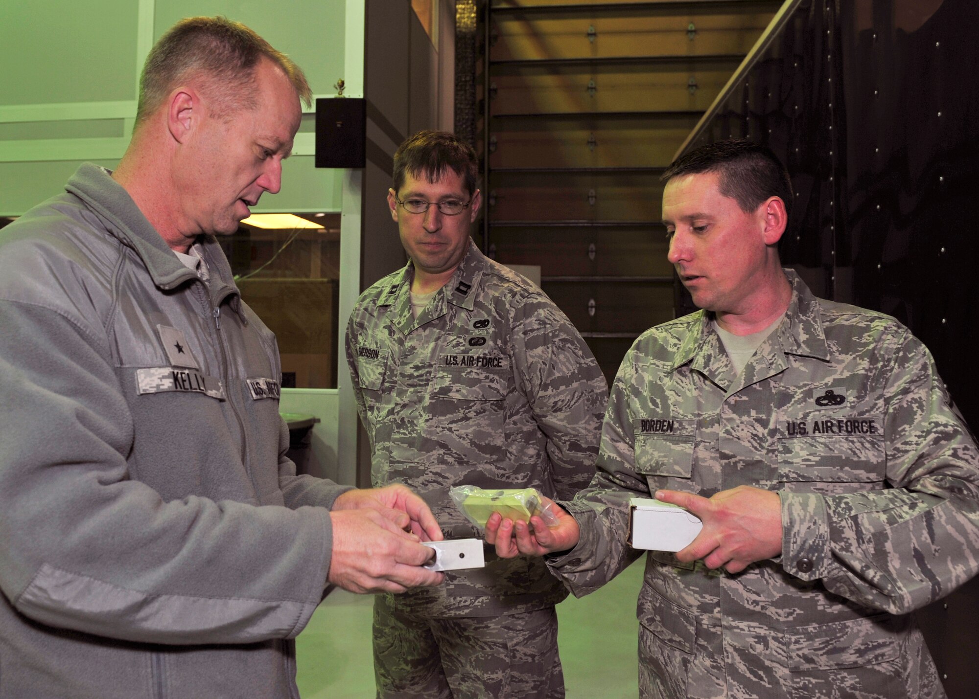 Brig. Gen. Mark Kelly, 354th Fighter Wing commander, inspects a piece of the wing’s flagship aircraft with Master Sgt. Joel Borden, 354th Maintenance Squadron inspections chief Oct. 7, 2013, Eielson Air Force Base, Alaska. The purpose of an aircraft phase is to inspect the plane inch by inch, finding any discrepancies that would keep it permanently grounded. (U.S. Air Force photo by Senior Airman Ashley Nicole Taylor/Released)