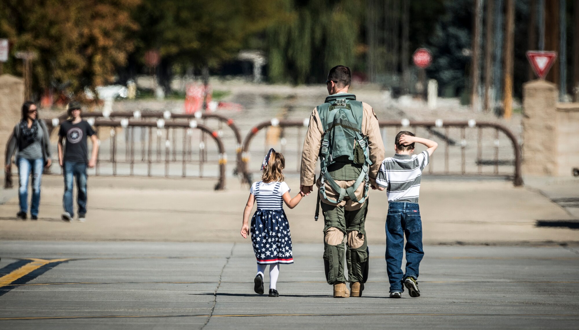 U.S. Air Force Lt. Col. Joel Meyers, 389th Fighter Squadron commander, walks with two of his children, reunited, at Mountain Home Air Force Base, Idaho, Oct. 5, 2013. Meyers was deployed with the 389th FS to Southwest Asia and had just returned that day. (U.S. Air Force photo by Tech. Sgt. Samuel Morse/RELEASED)
