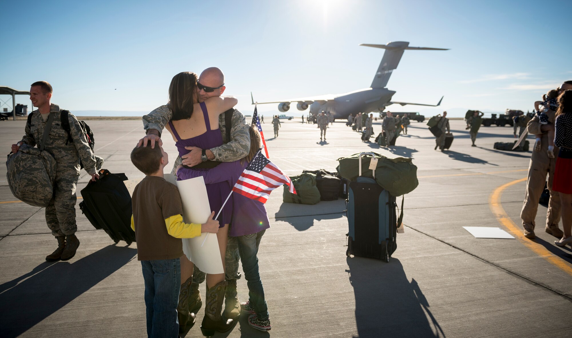 U.S. Air Force 1st Lt. Steven Draughon, 366th Aircraft Maintenance Squadron, reunites with his family at Mountain Home Air Force Base, Idaho, Oct. 5, 2013. Draughon was deployed to Southwest Asia and had just returned that day. (U.S. Air Force photo by Tech. Sgt. Samuel Morse/RELEASED)