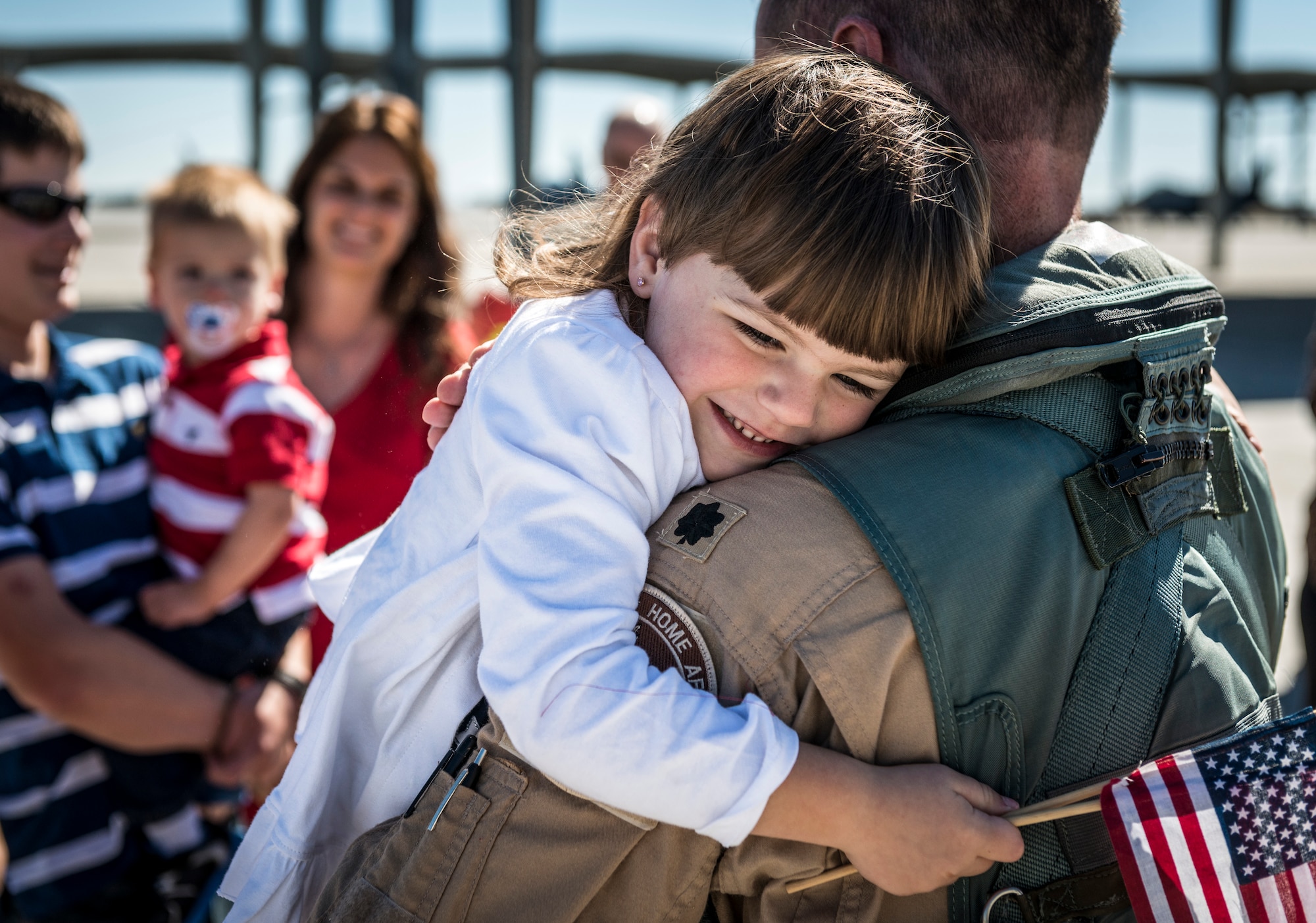 U.S. Air Force Lt. Col. Joel Meyers, 389th Fighter Squadron commander, embraces his daughter for the first time during a homecoming event welcoming the 389th Fighter Squadron back from its deployment to Southwest Asia at Mountain Home Air Force Base, Idaho, Oct. 5, 2013. (U.S. Air Force photo by Tech. Sgt. Samuel Morse/RELEASED)