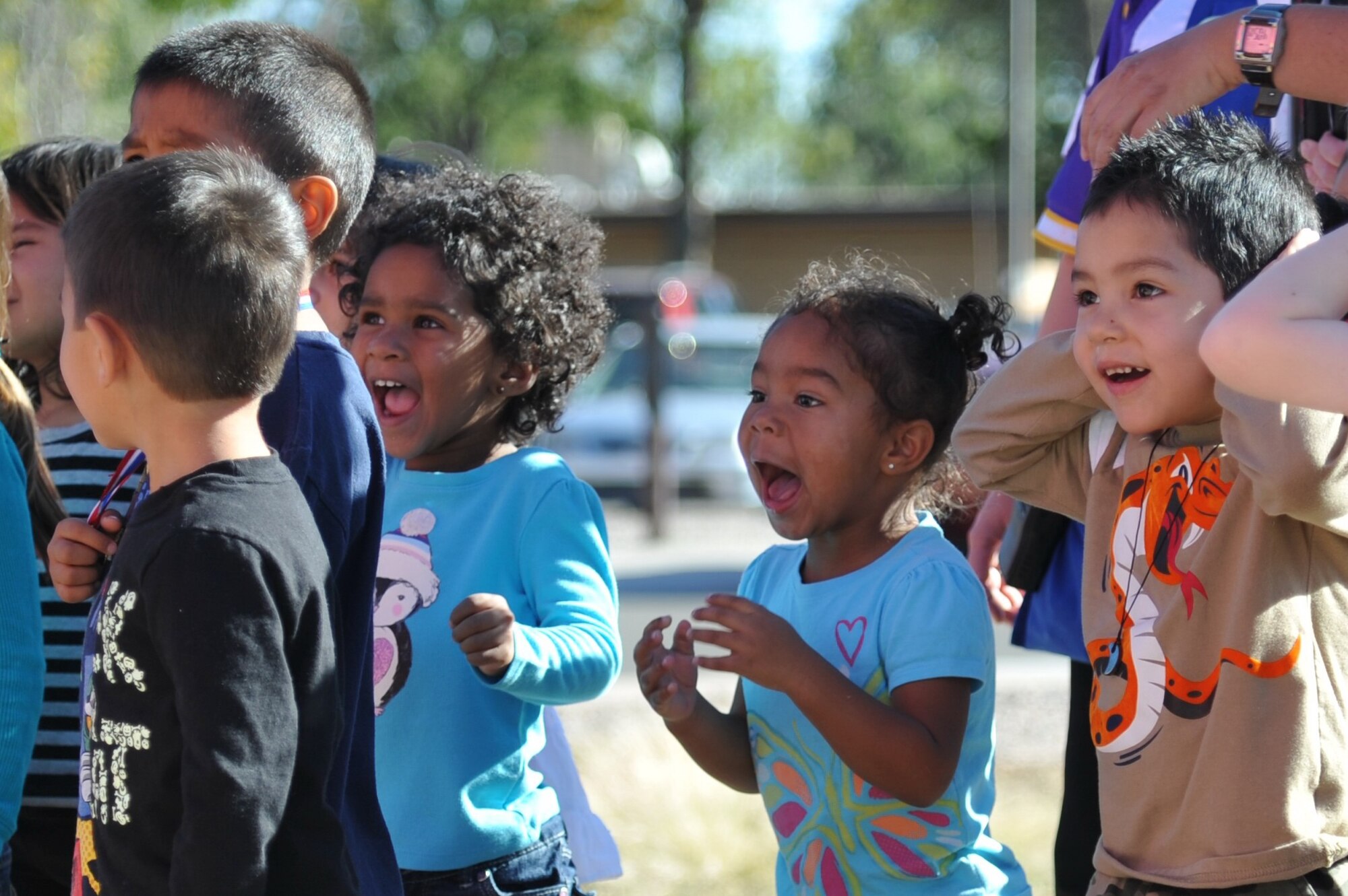 Children from Kirtland's Child Development Center look in wonderment at Nelly-B, a balloon piloted by a crew from Belgium. Nelly-B and its team made a stop at the CDC Oct. 7 on its way to the Albuquerque International Balloon Fiesta.  (Photo by Ken Moore)