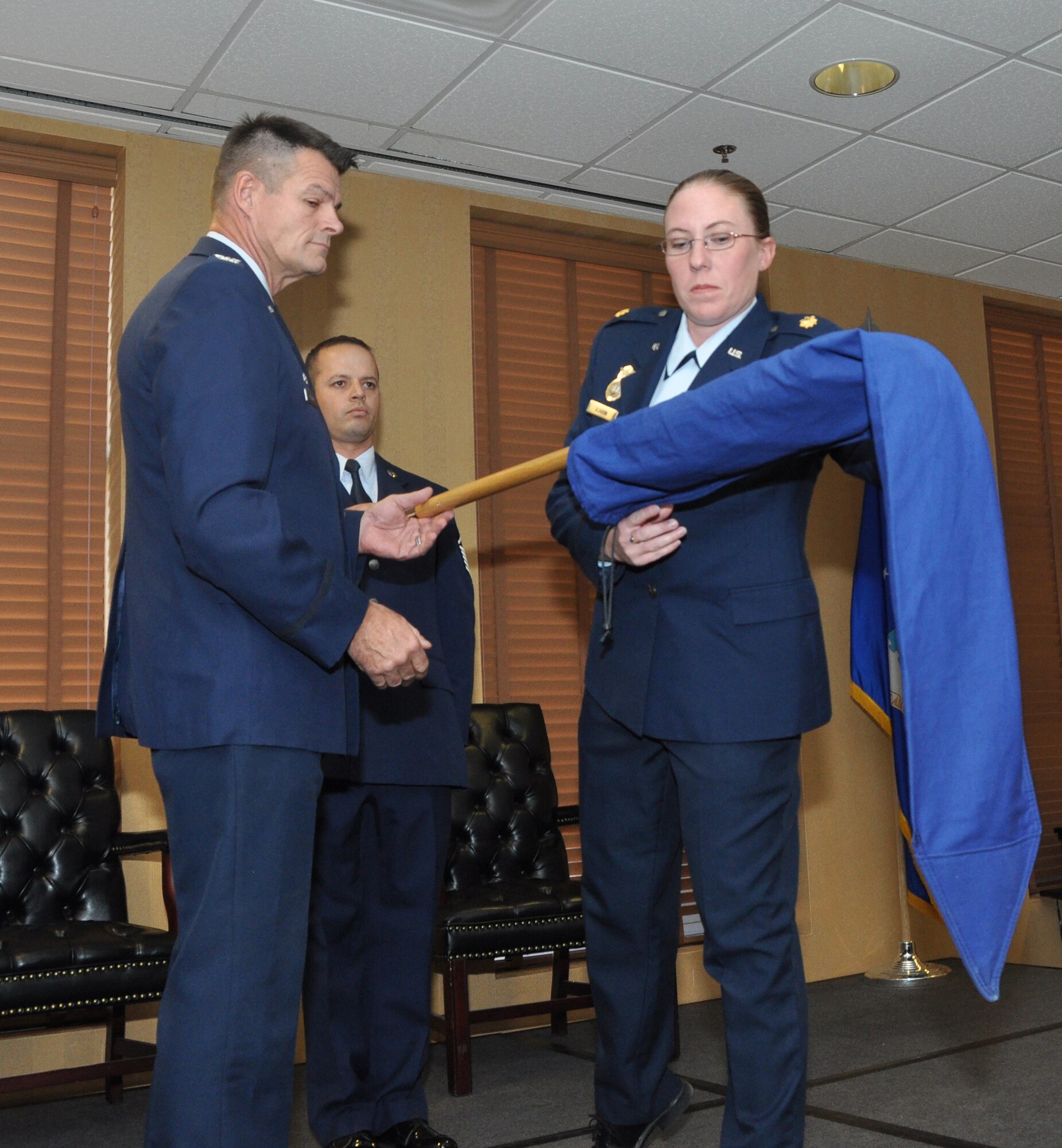 Col. Harold Maxwell, commander 943rd Rescue Group and Maj. Vaness Schoon, commander 720th SFS unfurl the new 720th SFS unit flag during the activation and assumption of command ceremony, Oct. 5. The 720th SFS will fall under the 920th Mission Support Group. (U.S. Air Force Photo/ Staff Sgt. Sarah M. Pullen)