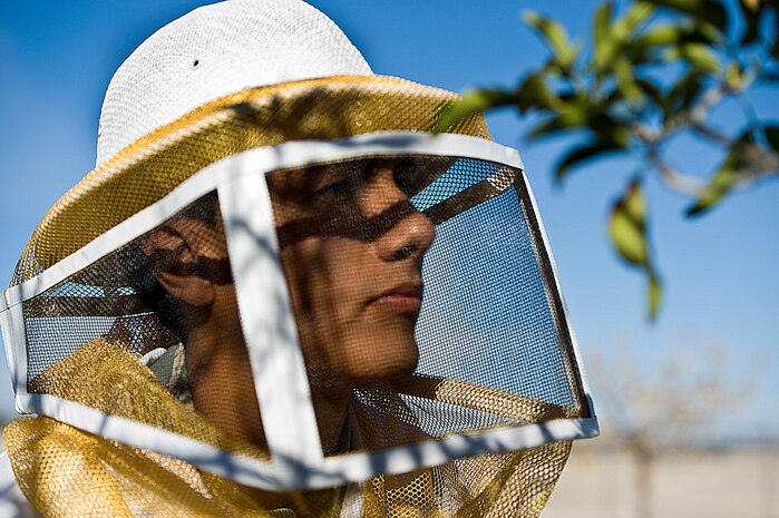 Senior Airman Jason Urquiola, 99th Civil Engineering Squadron pest management journeyman, prepares to spray insecticide outside the pest management building Oct. 8, 2013, at Nellis Air Force Base, Nev. Insecticide is used to exterminate and prevent bees and wasps around the base from becoming over populated. (U.S. Air Force photo by Airman 1st Class Christopher Tam)