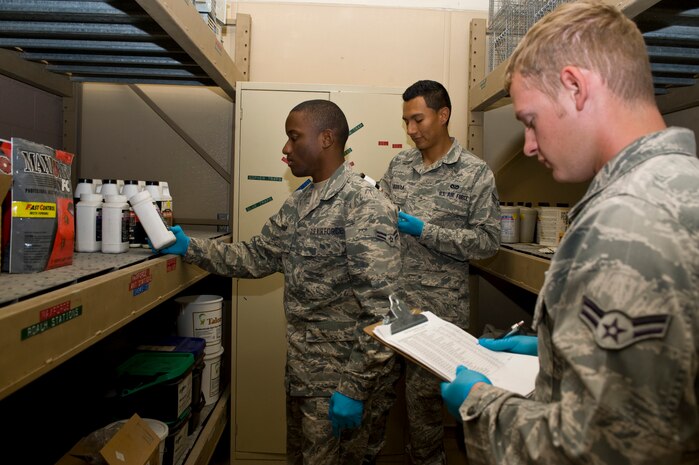 Airman 1st Class Steven Kaham (left), Senior Airman Jason Urquiola (middle), and Airman 1st Class David Dion (right), 99th Civil Engineering Squadron pest management journeymen, inventory the pest management supply room at Bldg. 1037 Oct. 2, 2013, at Nellis Air Force Base, Nev. Pest management has approximately 200 members Air Force-wide, and their mission is to ensure an environmentally sound and effective programs are present to prevent pests and disease vectors from adversely affecting Department of Defense operations.  (U.S. Air Force photo by Airman 1st Class Christopher Tam)