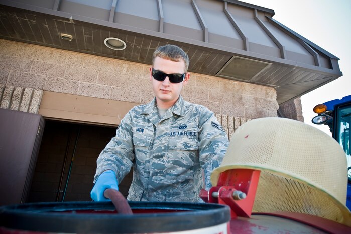 Airman 1st Class David Dion, 99th Civil Engineering Squadron pest management journeyman, pours herbicide into a tank outside of the pest management building  Oct. 2, 2013, at Nellis Air Force Base, Nev. Herbicide is a pesticide used to kill weeds and other unwanted plants.   The xeriscape or dry-scape [a water-wise landscaping] at Nellis AFB has weeds grow in between rocks and regular spraying controls and eliminates the growth. (U.S. Air Force photo by Airman 1st Class Christopher Tam)