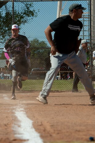 Michael Dreyer, Wounded Warrior Amputee Softball Team member, sprints to first base during a game against Nellis and Creech Air Force Bases’ Airmen at a baseball field at Freedom Park Oct. 5, 2013, at Nellis AFB, Nev. According to the WWAST’s website, the athletes are an examples of amputees who continue to push the limits of modern prosthetic technology with more and more applications. (U.S. Air Force photo by Airman 1st Class Timothy Young)