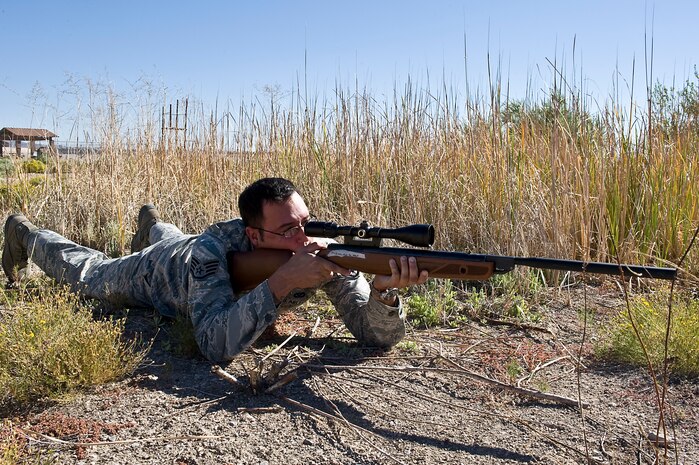 Staff Sgt. Jonathan Crespillo, 99th Civil Engineer Squadron pest management craftsman, prepares to shoot a pellet rifle near Bldg. 1037, Oct. 2, 2013, at Nellis Air Force Base, Nev. Pest management uses the Bird Aircraft Strike Hazard program to reduce potential bird strikes around the flightline and to prevent foreign object damage to aircraft flying at Nellis AFB. (U.S. Air Force photo by Senior Airman Matthew Lancaster)
