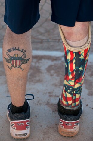 Todd Reed, Wounded Warrior Amputee Softball Team member, waits for his turn at bat during a Wounded Warrior softball game at the baseball field at Freedom Park Oct. 5, 2013, at Nellis Air Force Base, Nev. The WWAST played against Airmen from Nellis and Creech AFBs during a double header. Reed has a tattoo of the WWAST logo on his left calf. (U.S. Air Force photo by Staff Sgt. Christopher Hubenthal)