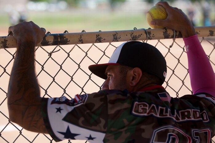 Michael Gallardo, Wounded Warrior Amputee Softball Team member, watches his team members on the baseball field as he waits his turn at bat during a Wounded Warrior softball game at Freedom Park Oct. 5, 2013, at Nellis Air Force Base, Nev.  The WWAST played against Airmen from Nellis and Creech AFBs during a double header. The Nellis and Creech AFBs’ softball team defeated the WWAST 15-10 and 25-11.  (U.S. Air Force photo by Staff Sgt. Christopher Hubenthal)