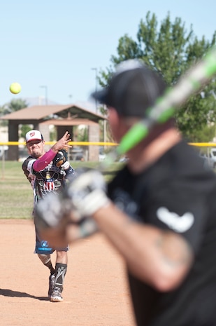 Michael Dreyer, Wounded Warrior Amputee Softball Team member, pitches a ball during a Wounded Warrior softball game at the baseball field at Freedom Park Oct. 5, 2013, at Nellis Air Force Base, Nev. Airmen from Nellis and Creech AFBs defeated the Wounded Warrior Amputee Softball Team 15-10 and 25-11 during a double header. While some WWAST members still serve in the military, others attend college with the Post-9/11 GI Bill. (U.S. Air Force photo by Staff Sgt. Christopher Hubenthal)