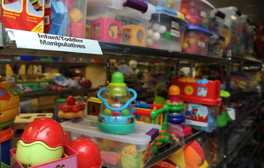 Infant and toddler toys rest on a shelf at the Family Child Care Program facility on Barksdale Air Force Base, La., Oct. 8, 2013. The FCCP provides all of the necessary equipment and supplies for license providers to use in their home. Providers can check out anything from an infant toy to a chemistry set for a 12 year old. (U.S. Air Force photo/Senior Airman Joseph A. Pagán Jr.)