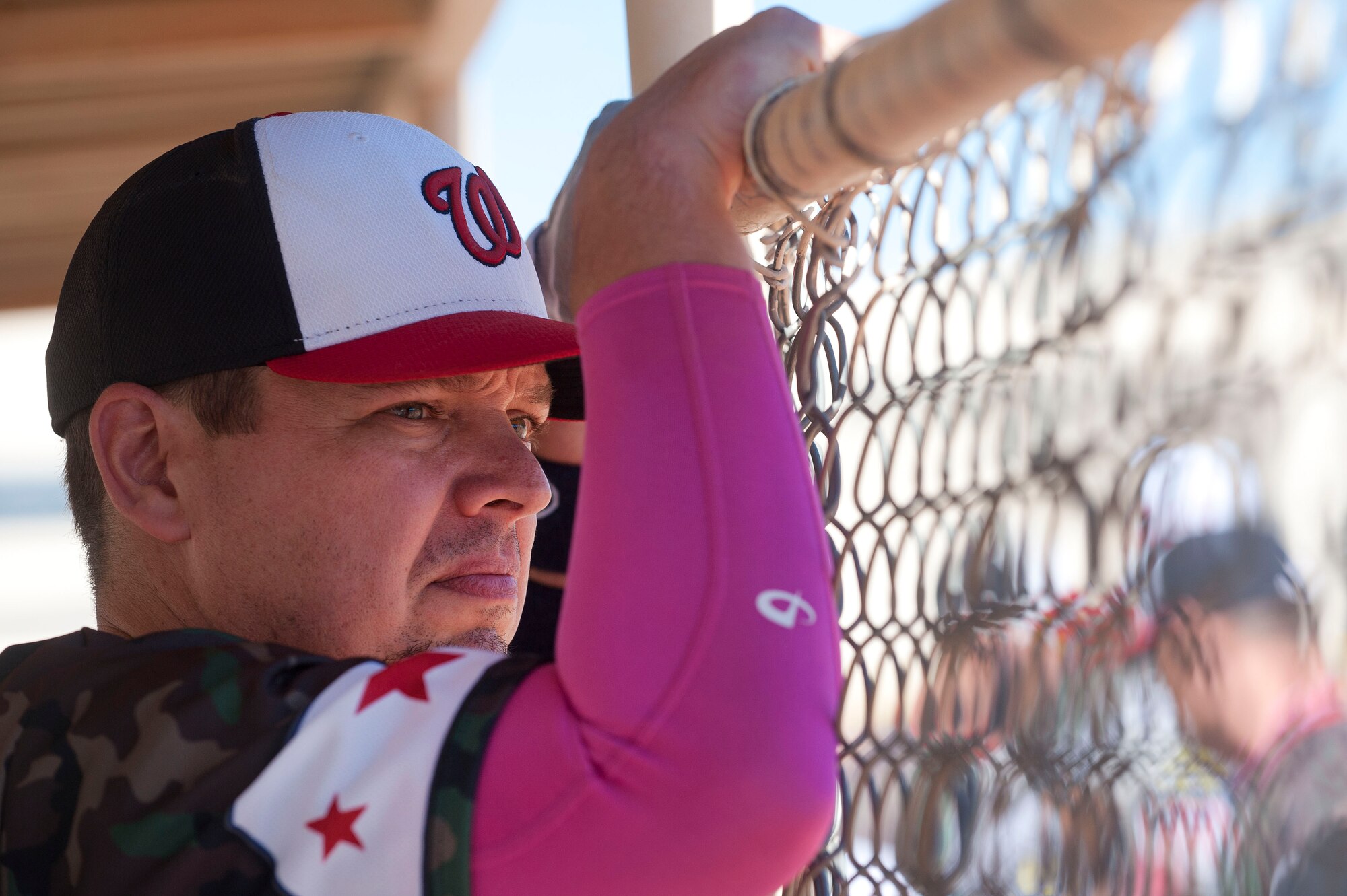 Michael Dreyer, Wounded Warrior Amputee Softball Team member, watches his teammates on the baseball field as he waits to bat during a Wounded Warrior softball game at Freedom Park Oct. 5, 2013, at Nellis Air Force Base, Nev. The WWAST played against Airmen from Nellis and Creech AFBs during a double header. WWAST members strive to show other amputees and the general population that through extensive rehabilitation, hard training and the use of modern prosthetic technology that they can achieve their goals. (U.S. Air Force photo by Staff Sgt. Christopher Hubenthal)