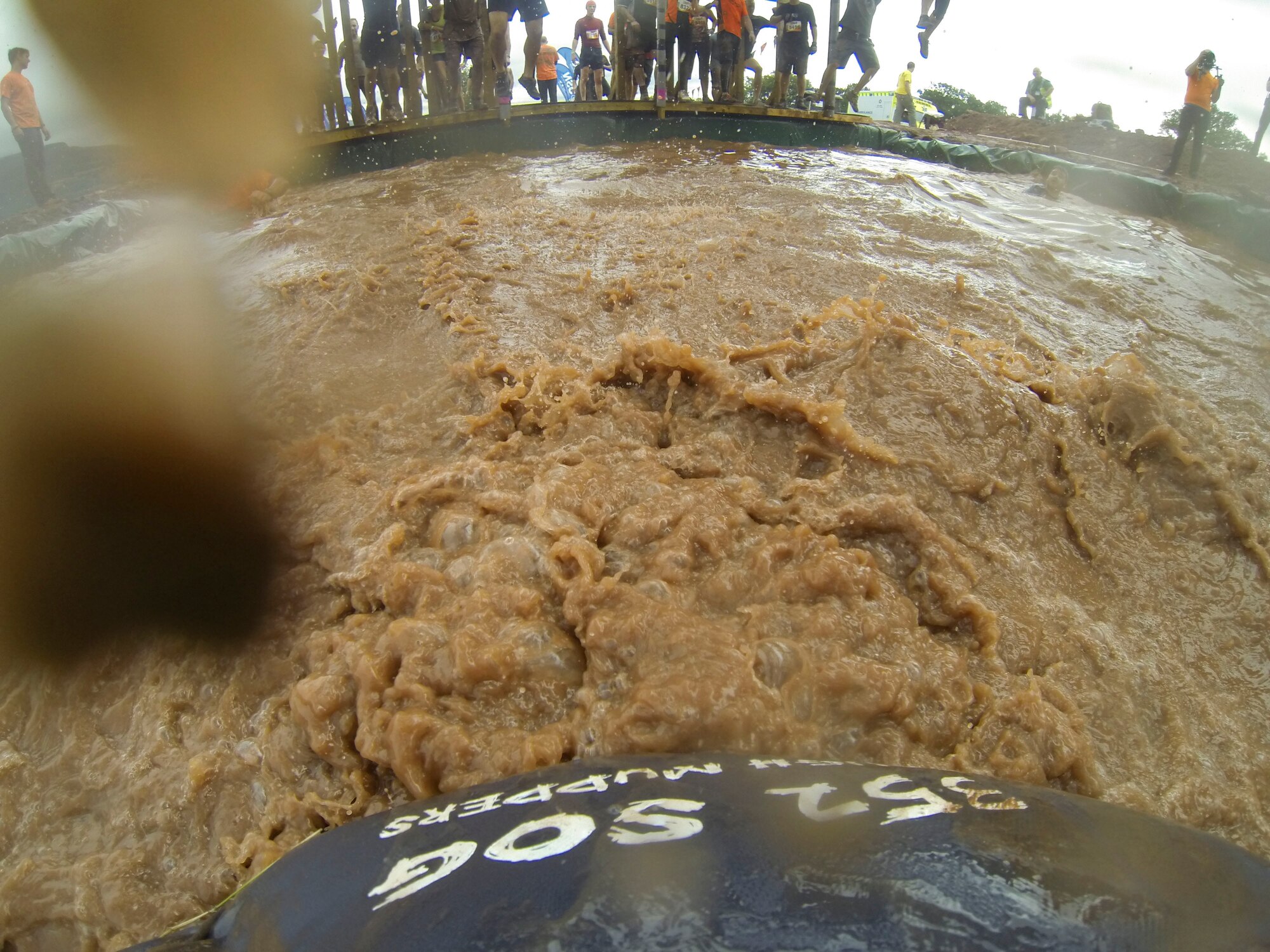 A “352 SOG Tough Mudders” team member falls into water while attempting to complete an obstacle at the Tough Mudde U.K. Southwest 2013 event Sept. 21, 2013, at Crickhowell, Wales. All the members of the “352 SOG Tough Mudders” team completed the 11-mile obstacle course, which according to Tough Mudder’s website, is “designed to test ones strength, stamina, determination and camaraderie.” (Courtesy Photo)

