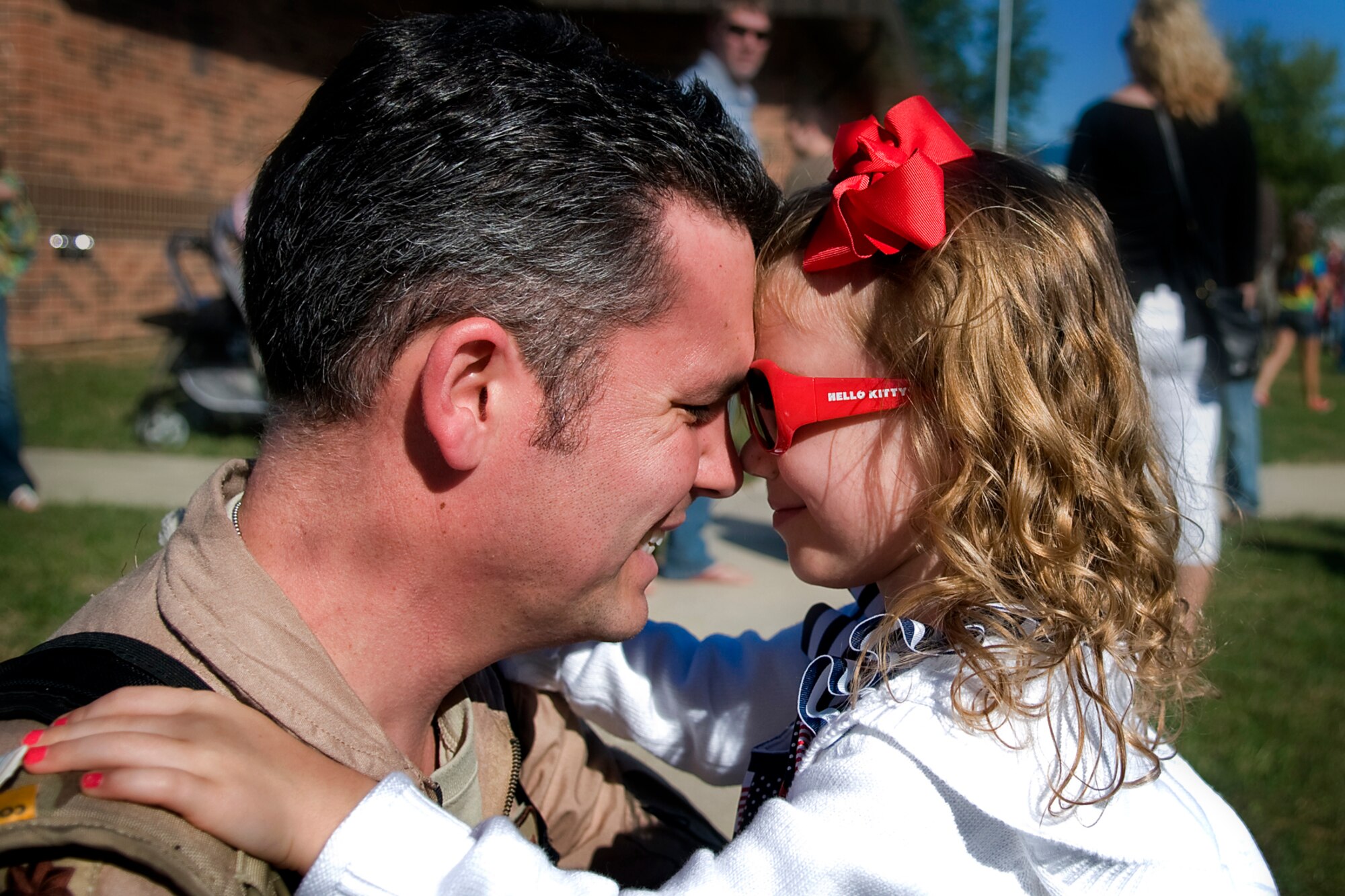 Maj. Chadd Kobielush, 434th Operations Support Squadron operations officer, shares a moment with his daughter, Ella, after returning to Grissom Air Reserve Base, Ind., from a deployment to Southwest Asia Sept. 22, 2013. Kobielush returned to the Hoosier heartland with more than 60 other Airman who deployed from the 434th Air Refueling Wing. (U.S. Air Force photo/Tech. Sgt. Mark R. W. Orders-Woempner)