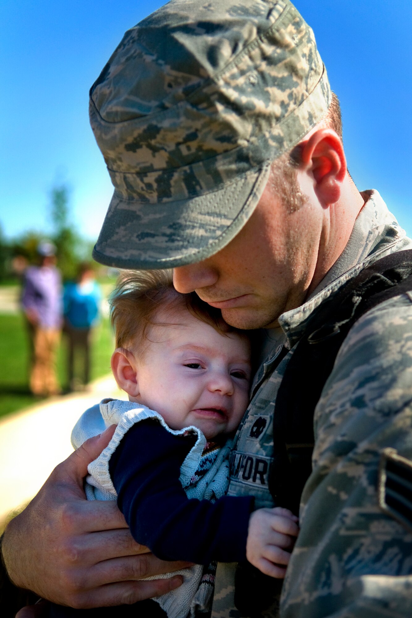 Senior Airman Dustin Neu, 434th Aircraft Maintenance Squadron KC-135 crew chief, holds his daughter, Summer, for the first time at Grissom Air Reserve Base, Ind., after returning from a deployment to Southwest Asia Sept. 22, 2013. Summer was born while Neu was deployed, and he had only seen her in photos and videos before he redeployed to Grissom with more than 60 other 434th Air Refueling Wing Airmen. (U.S. Air Force photo/Tech. Sgt. Mark R. W. Orders-Woempner)
