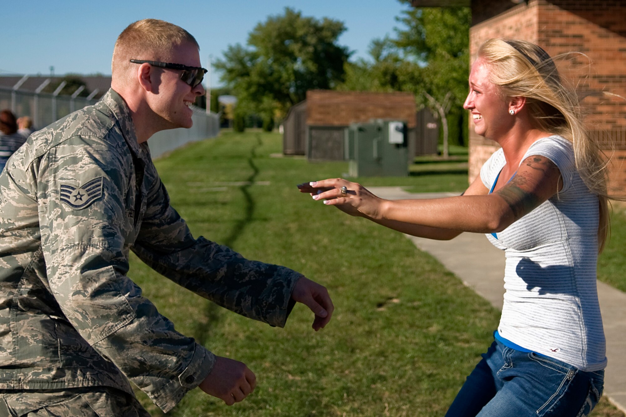 Staff Sgt. Travis Helton, 434th Aircraft Maintenance Squadron aircraft electronic and environmental systems journeyman, prepares to catch his  wife, Amanda, as she greets him by jumping into his arms after he returned from a deployment to Grissom Air Reserve Base, Ind.,  Sept. 22, 2013. Helton returned to Grissom with more than 60 other Airman who deployed to Southwest Asia from the 434th Air Refueling Wing. (U.S. Air Force photo/Tech. Sgt. Mark R. W. Orders-Woempner)
