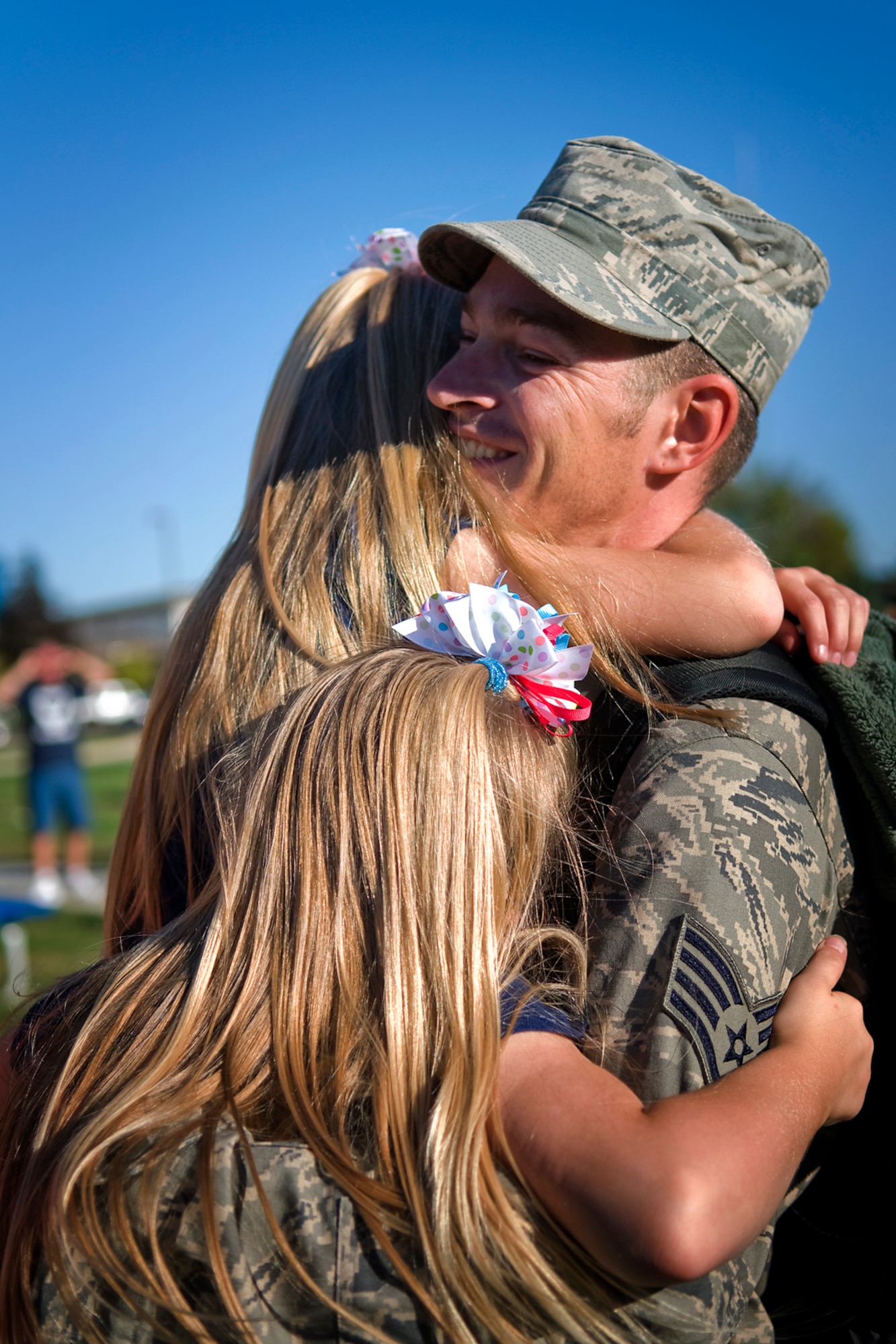 Staff Sgt. Craig Ward, 434th Aircraft Maintenance Squadron KC-135 crew chief, is welcomed home from a deployment to Southwest Asia by daughters, Rachael and Kiley, at Grissom Air Reserve Base, Ind., Sept. 22, 2013. Ward was also welcomed by his wife, April, and son Bradley, as he returned to Grissom with more than 60 other Airman who deployed from the 434th Air Refueling Wing. (U.S. Air Force photo/Tech. Sgt. Mark R. W. Orders-Woempner)

