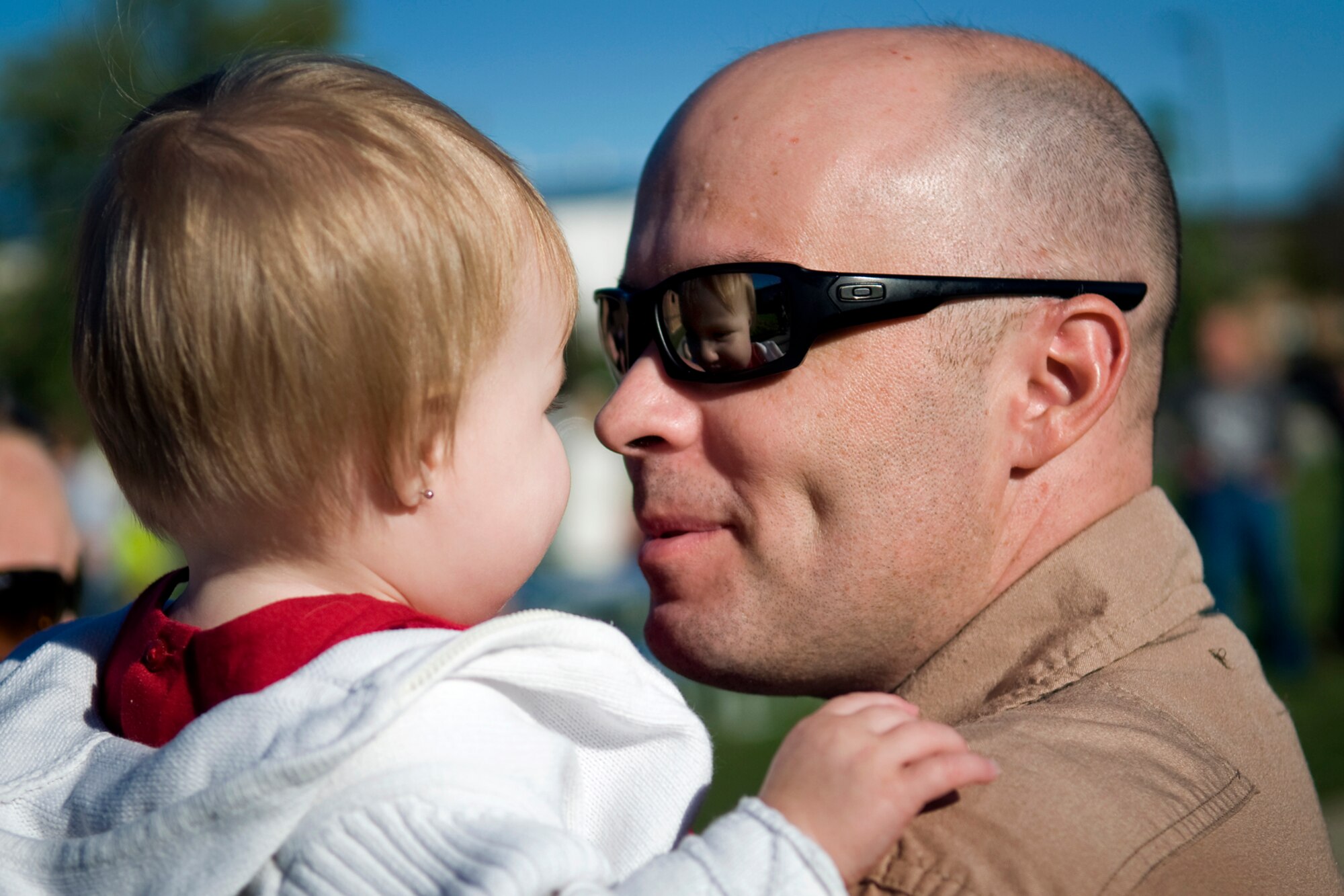 Maj. Rob Schneider, 72nd Air Refueling Squadron instructor pilot, shares a moment with his daughter Anne, after returning to Grissom Air Reserve Base, Ind., from a deployment to Southwest Asia Sept. 22, 2013. Schneider received double the welcome as he was also able to share a similar moment with his son and Anne's twin brother, William. (U.S. Air Force photo/Tech. Sgt. Mark R. W. Orders-Woempner)
