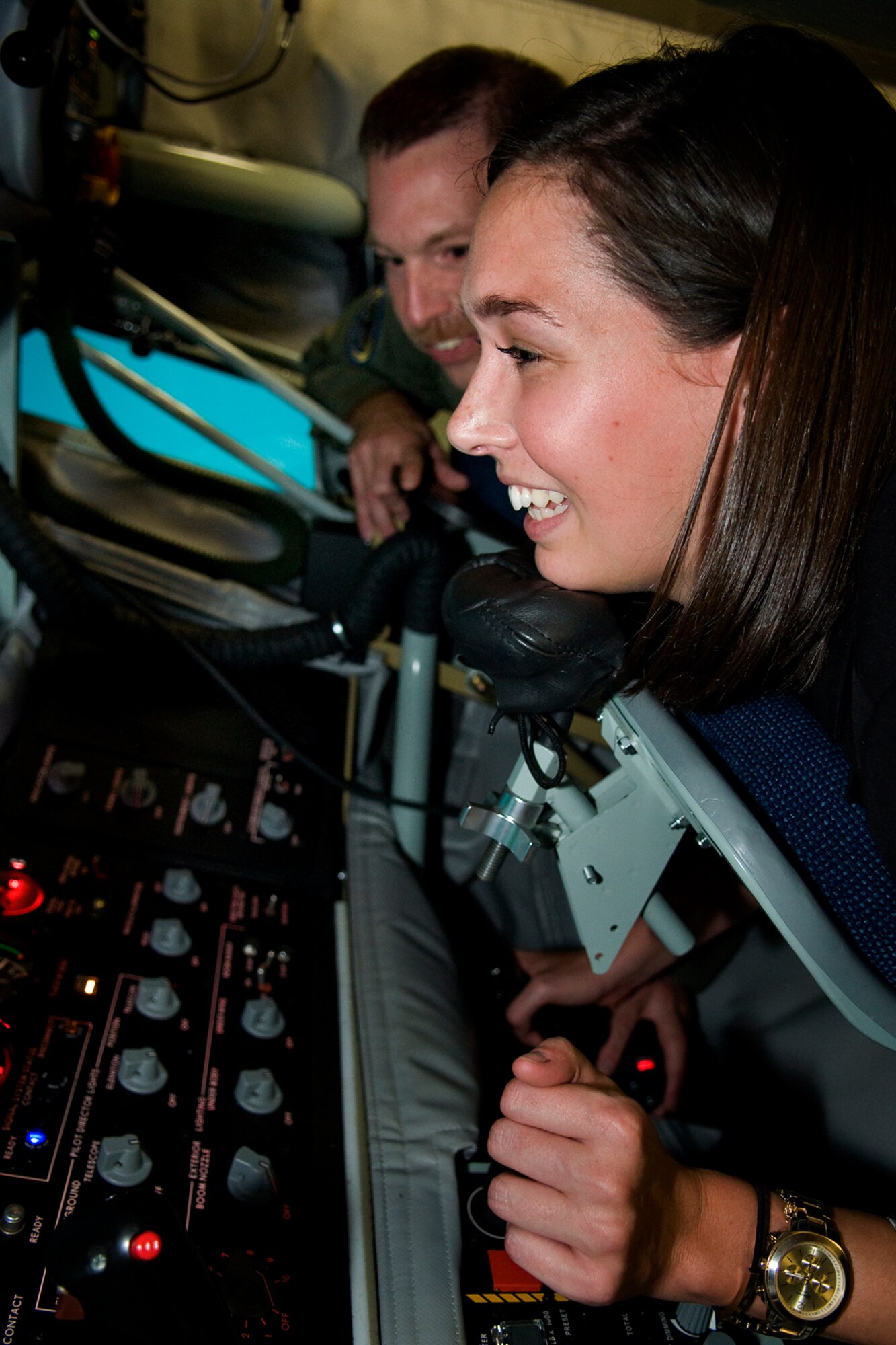 Master Sgt. Paul Sherrod, 72nd Air Refueling Squadron boom operator, instructs Meredith Perks, a regional director for Sen. Joe Donnelly, as she takes her shot in making a connection with an F-22 Raptor in a new boom operator weapons system trainer at Grissom Air Reserve Base, Ind., Sept. 27, 2013. Grissom is the first Air Force Reserve Command base to have a BOWST, which will allow KC-135 Stratotanker boom operators to conduct vital training in a virtual environment. (U.S. Air Force photo/Tech. Sgt. Mark R. W. Orders-Woempner) 